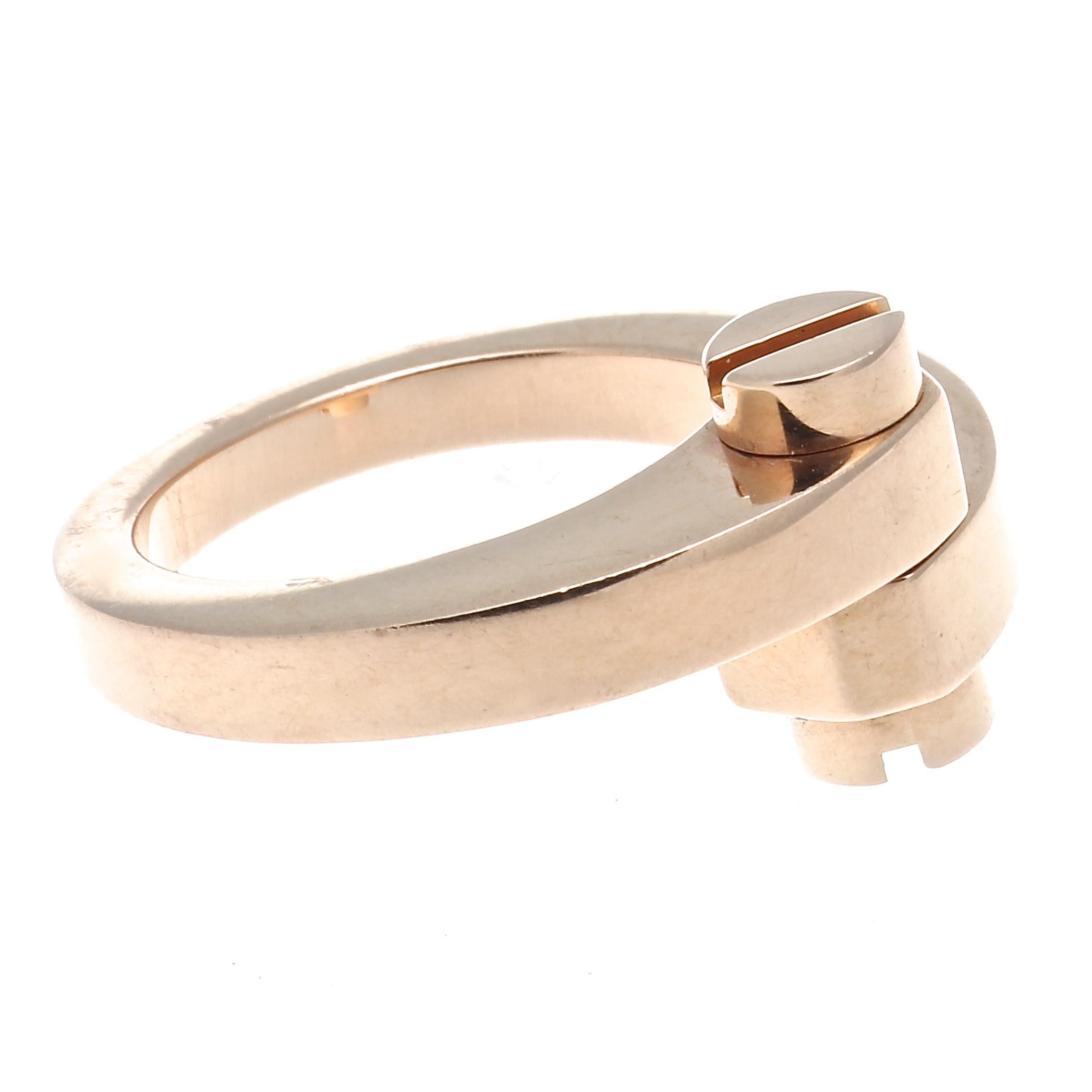 A Cartier classic, subtle details that displays their refined taste and expertise in creating styles that never are forgotten. Designed with swooping lines of 18k rose gold tightly secured by two screws. Signed Cartier and numbered.

Ring size 54 or