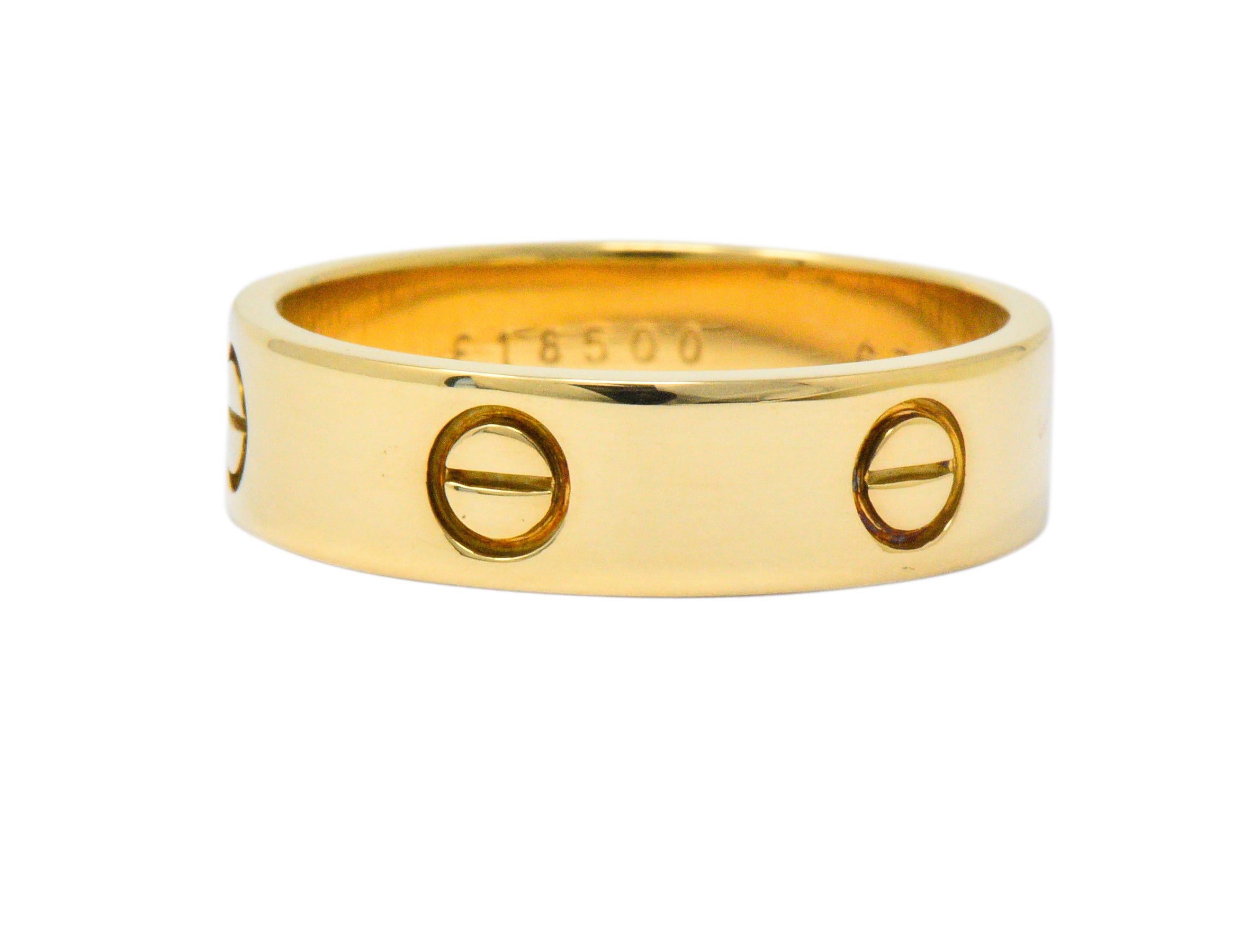 Featuring a solid gold highly polished band ring

Intermittent repeating symbol encompassing  band

From the Love Collection and circa 1990

Fully signed Cartier 750 E18500 63

Measures 6 mm wide and 1 mm thick

Total Weight: 8.2 grams

Ring Size: