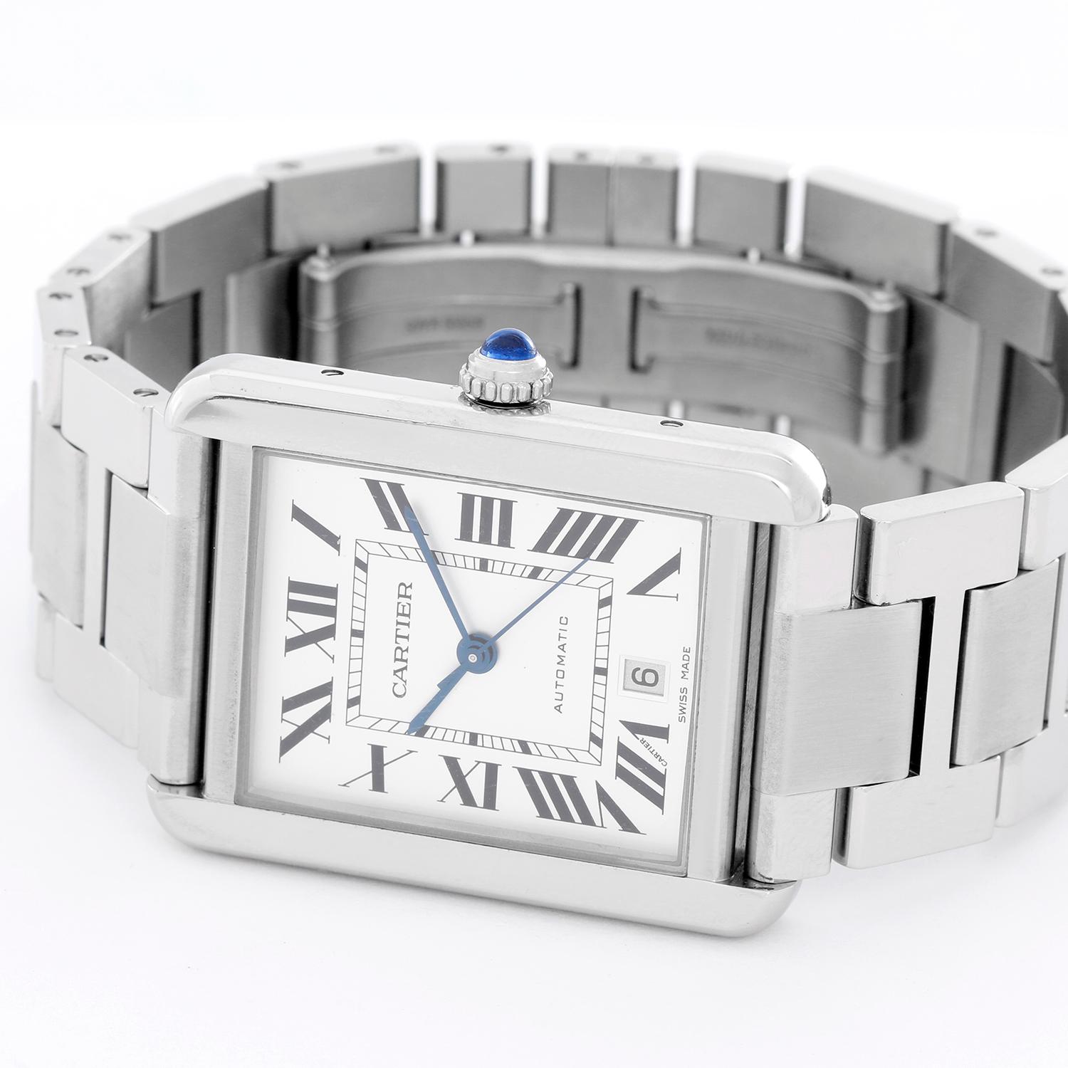 Cartier Men's Extra Large Tank Solo Stainless Steel Watch W5200028 - Automatic.  Stainless steel case ( 31 mm x 41 mm ). Silver dial with black Roman numerals with date at 6 o'clock.  Stainless steel with double deployant buckle. Pre-owned with