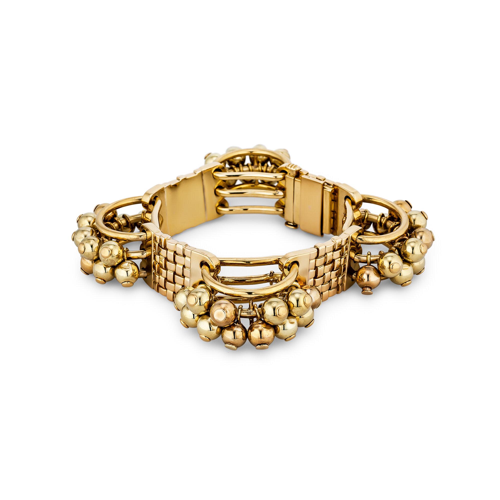 This Cartier three dimensional 18 karat yellow gold link bracelet is wearable fine art.  Four half sphere links featuring 12 moveable balls each are connected to four woven stylized rectangular links, creating a bracelet that is a one-of-a-kind