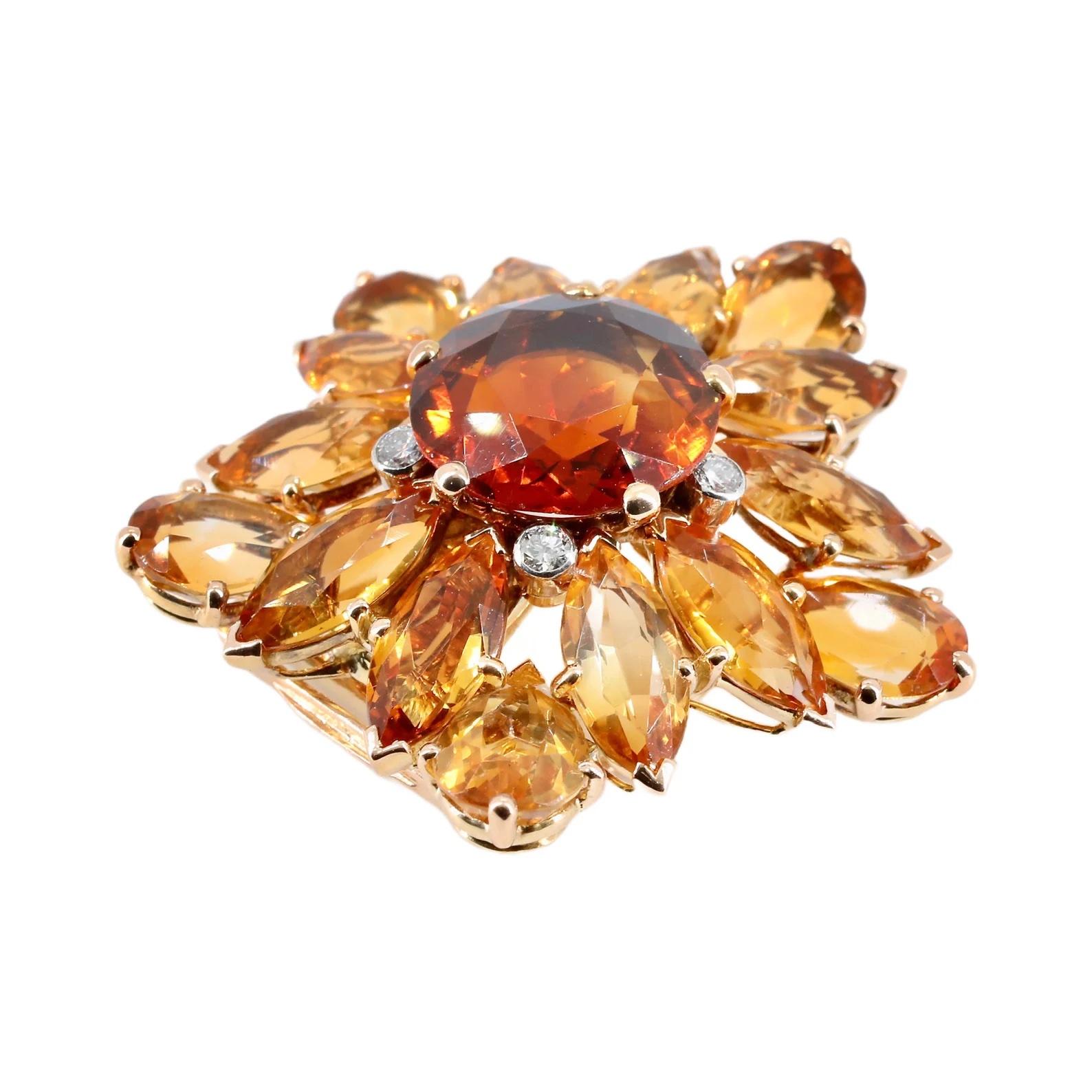 Llamativo broche de clip Cartier con forma de girasol de mediados de siglo. Elaborado en oro amarillo de 18 quilates, este broche en flor está centrado por un rico granate espesartina de 10 quilates. 

De color naranja intenso y profundo, el granate