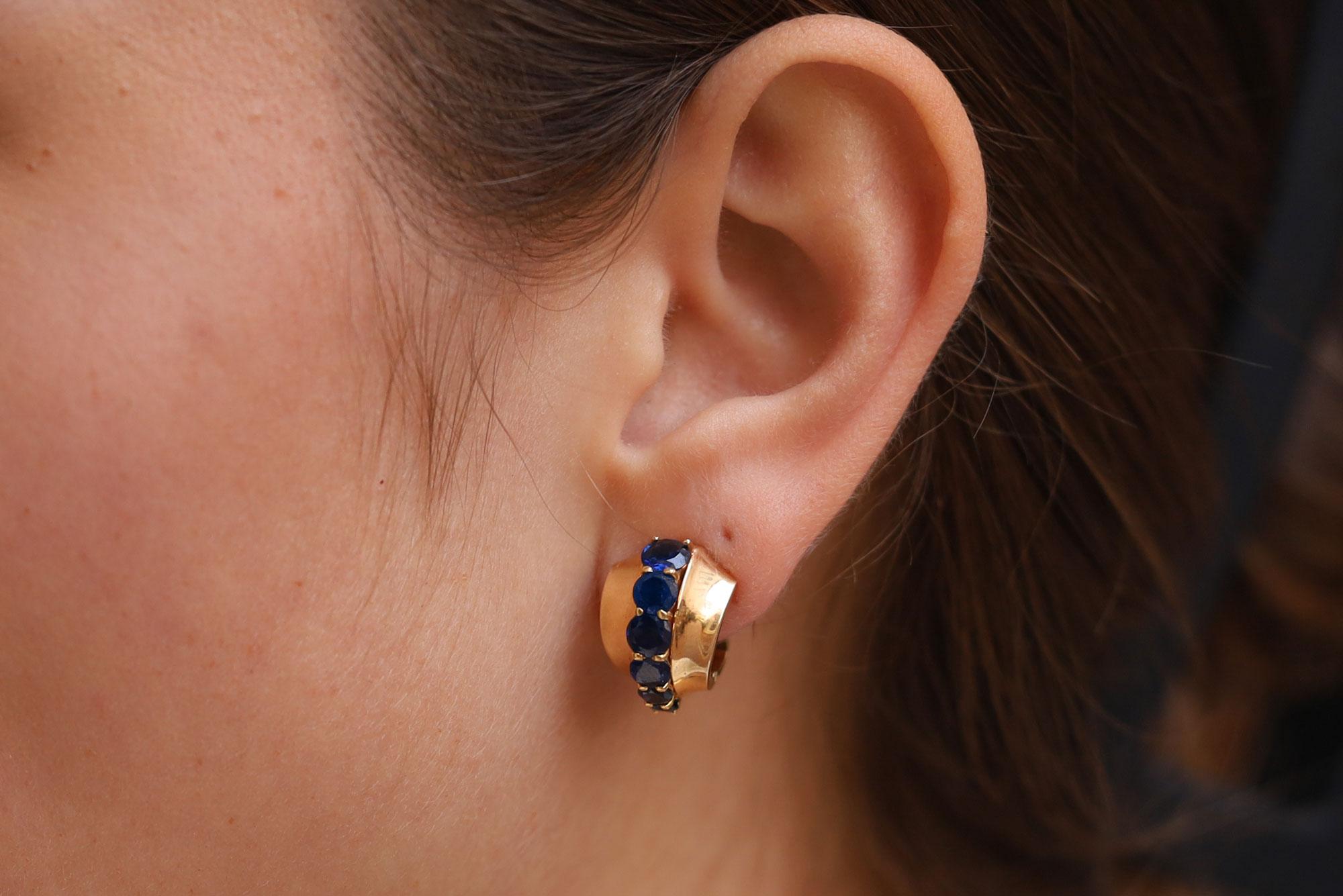 Diese signierten Cartier-Ohrringe aus der Mitte des Jahrhunderts sind ein außergewöhnlicher Fund, perfekt für Ihre Vintage-Designer-Schmuckkollektion. 2,75 Karat natürlicher, feiner blauer Saphire verjüngen sich in den 14-karätigen Reifchen mit
