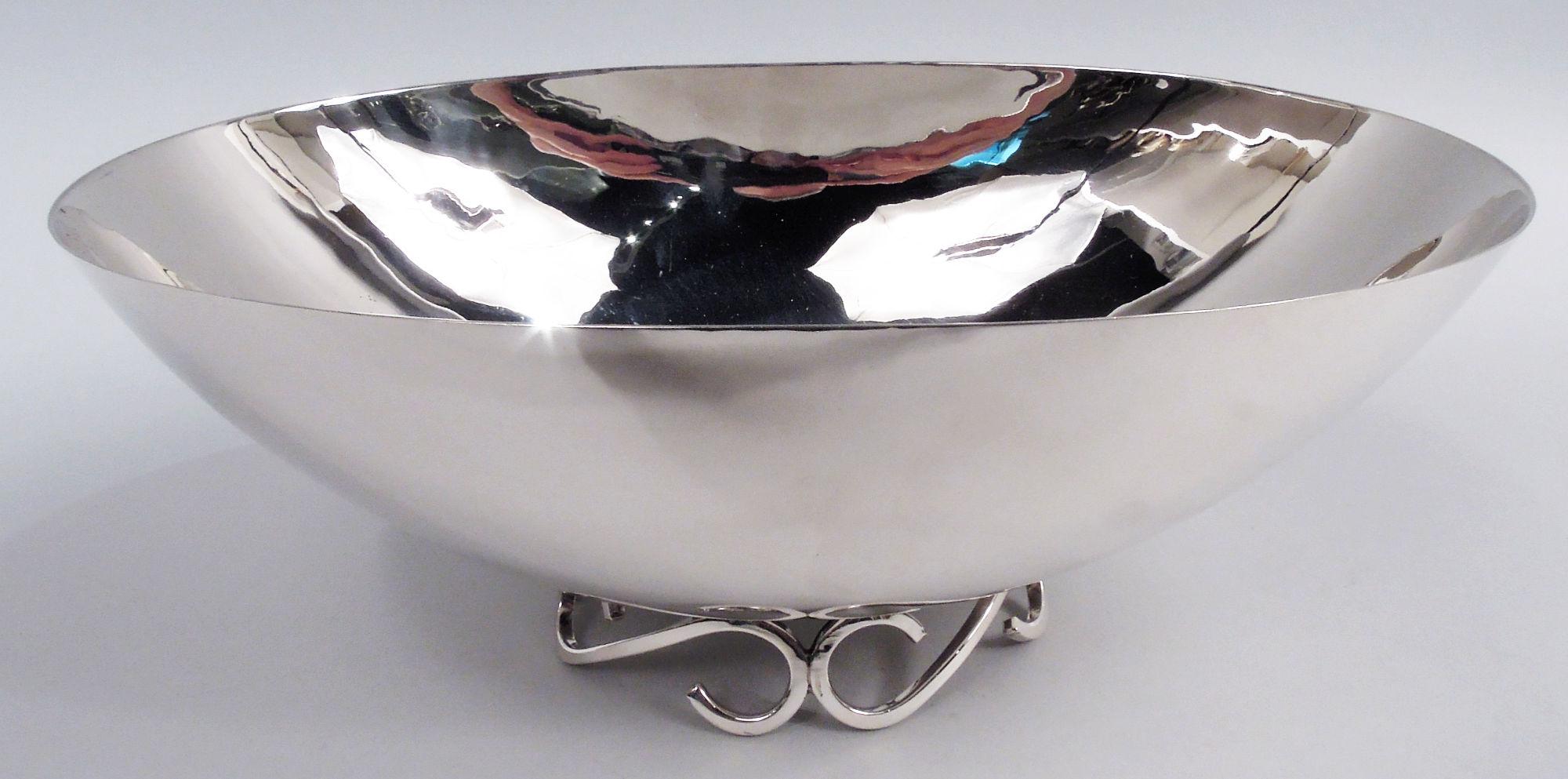 Cuenco de plata de ley moderno de mediados de siglo. Fabricado por Alfredo Sciarrotta para Cartier en Nueva York. Oval con lados curvados; martillado puntual en todo el contorno. Pie oval abierto compuesto por cuatro volutas en 