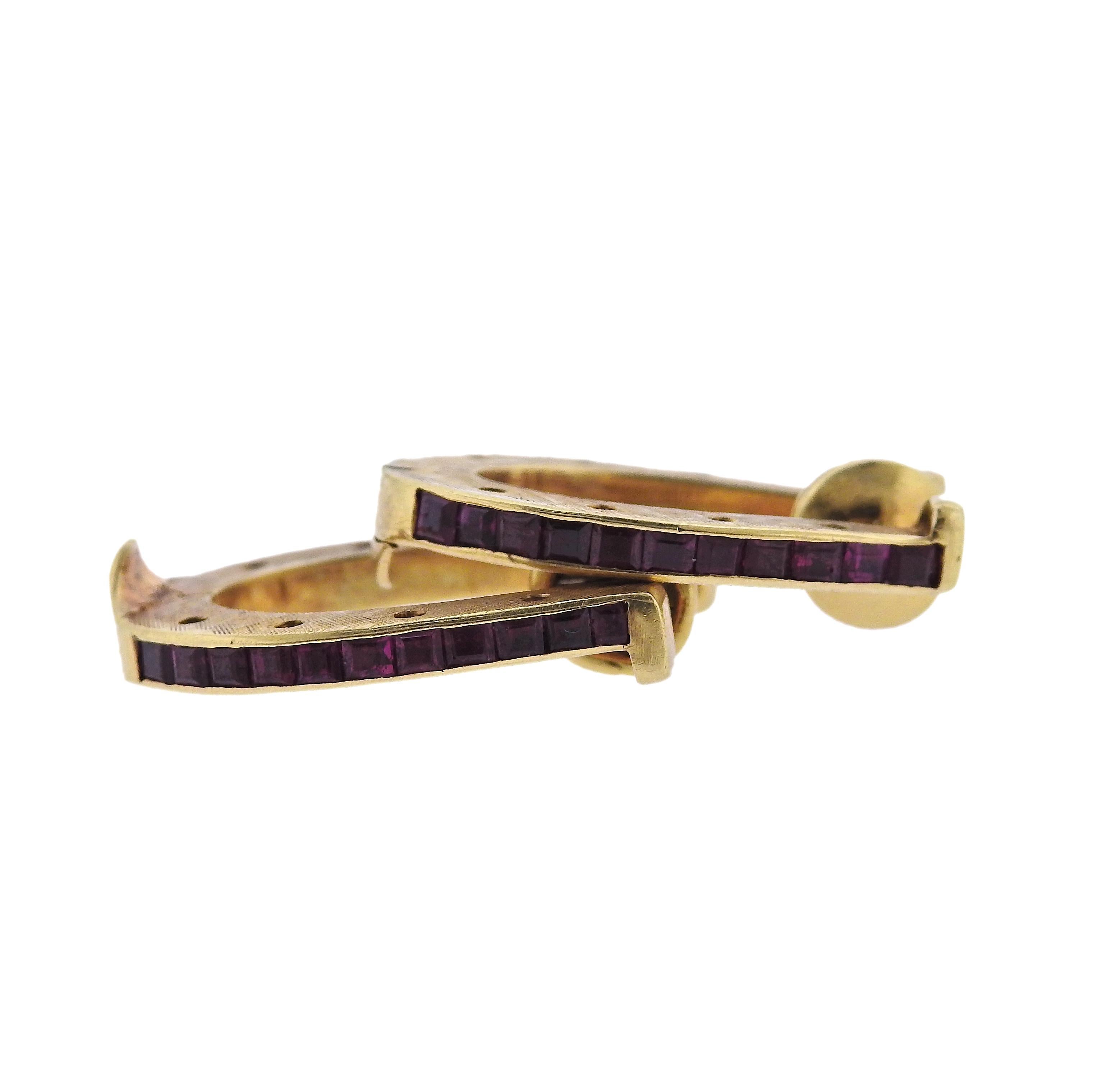 Pair of Midcentury 18k gold cufflinks by Cartier, with rubies and approx. 0.70ctw G/VS diamonds. Cufflink measures 25mm x 20mm, one cufflink is slightly bent on the side,   width 3mm. Marked: Cartier, 18k,  28267.  Weight - 14.6 grams. 