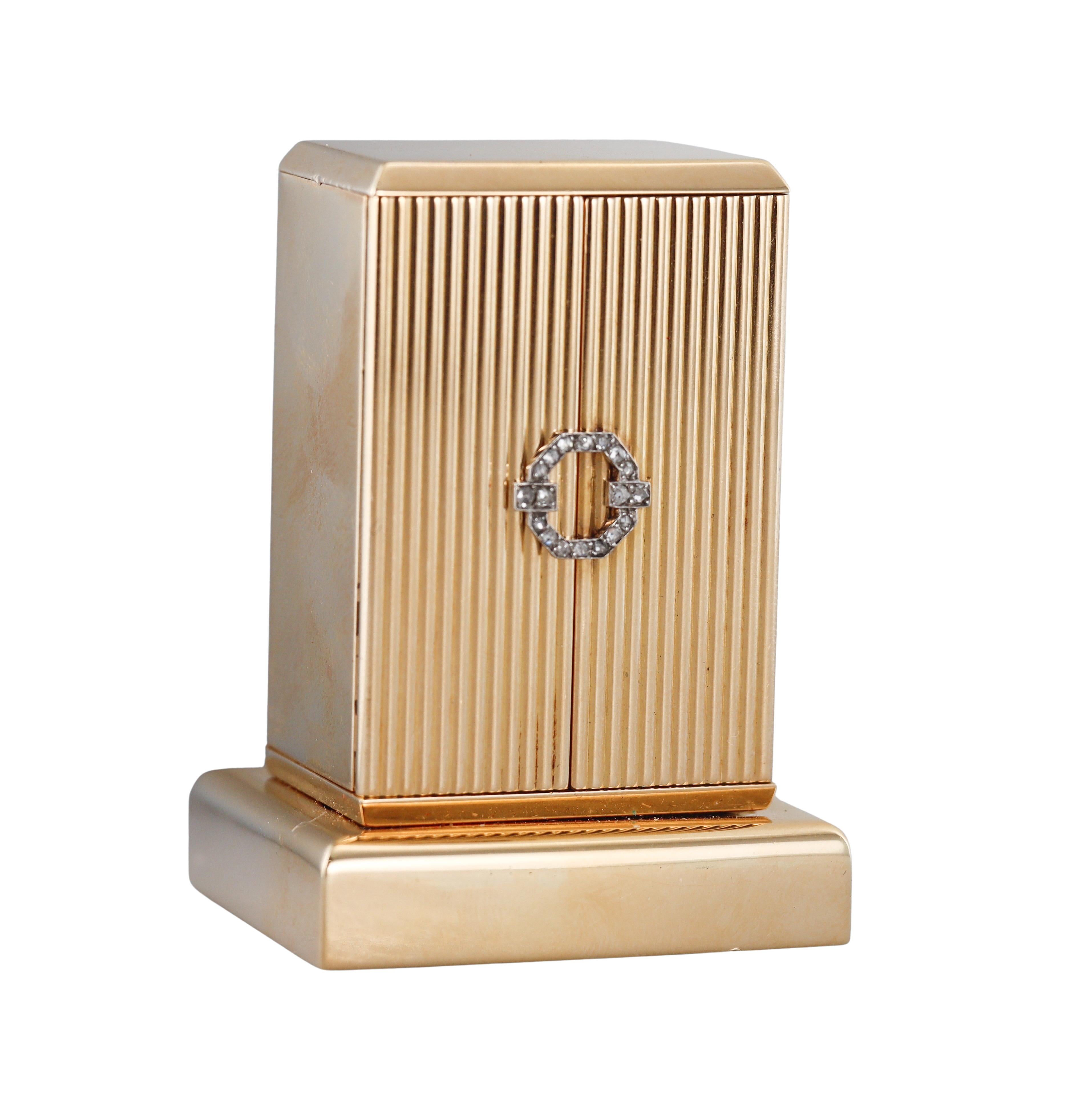 Midcentury circa 1950s 18k gold desk clock by Cartier, door decorated with rose cut diamonds.  Black applied Roman markers. Clock measures 2.25