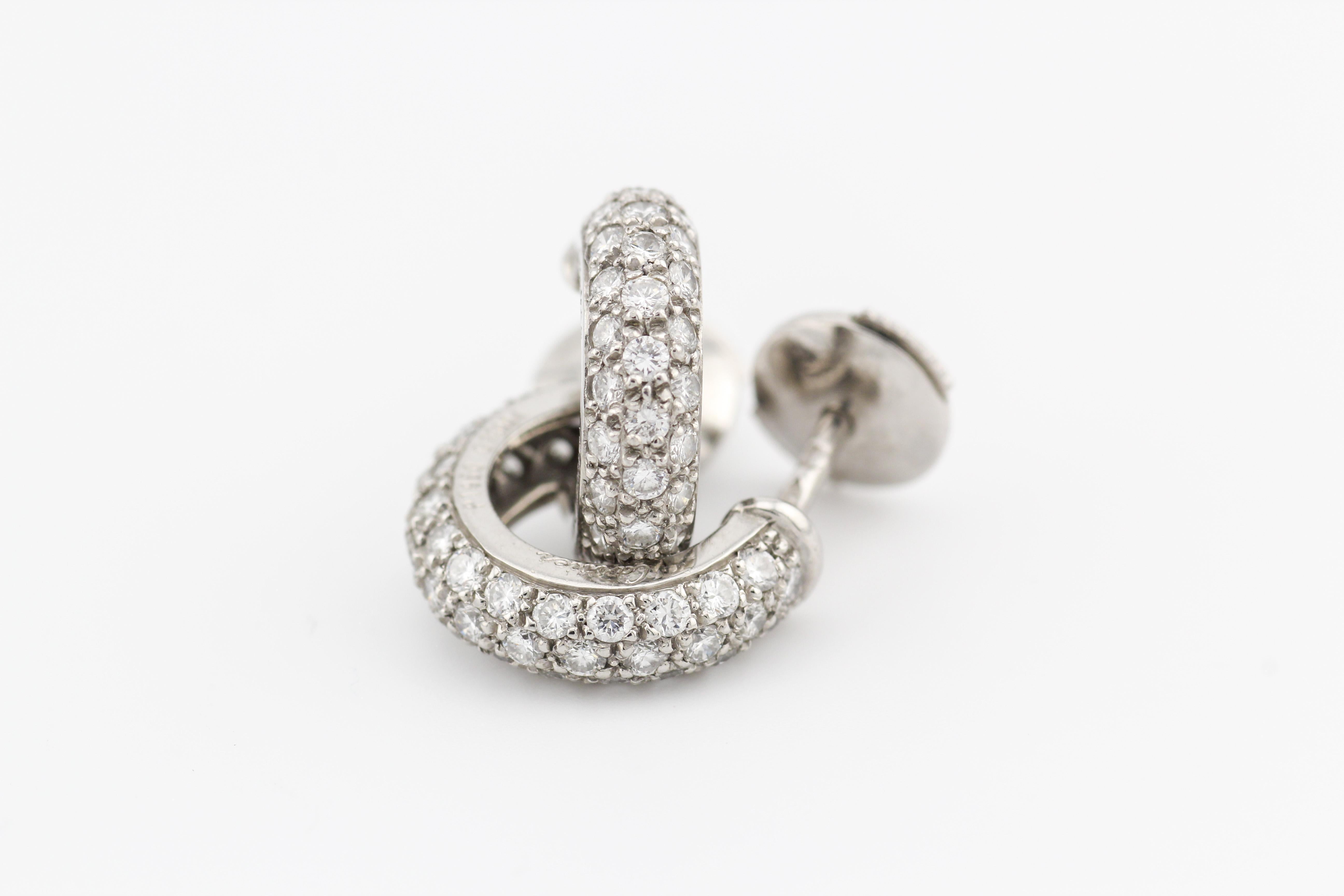 Elevate your elegance with the Cartier Mimi Diamond Platinum Hoop Earrings—a dazzling embodiment of sophistication and luxury. Crafted by the esteemed house of Cartier, these earrings showcase the brand's commitment to excellence in design and