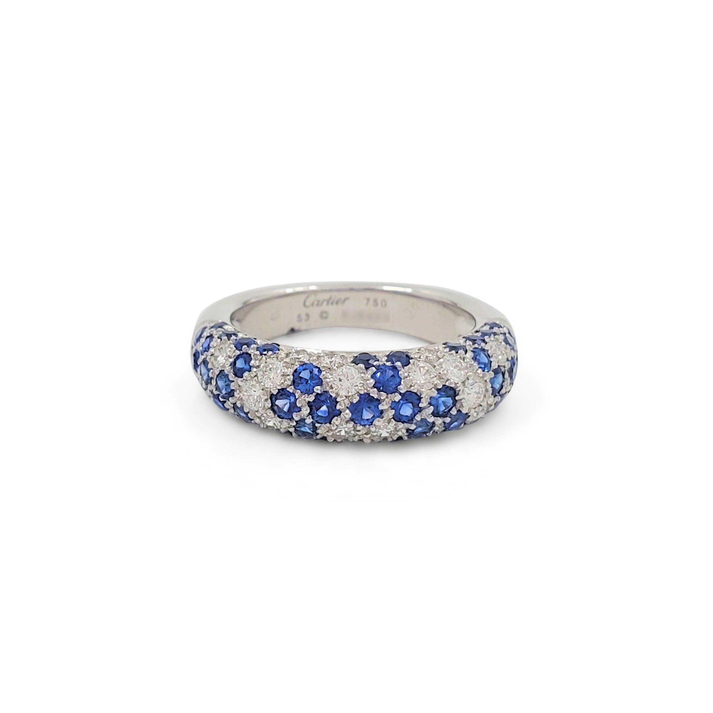 Authentic Cartier 'Mimi Star' dome-shaped ring crafted in 18 karat white gold is set with vivid blue sapphires and sparkling round brilliant cut diamonds (E-F, VS) weighing an estimated 0.38 carats total. Signed Cartier, 750, 53, with serial number