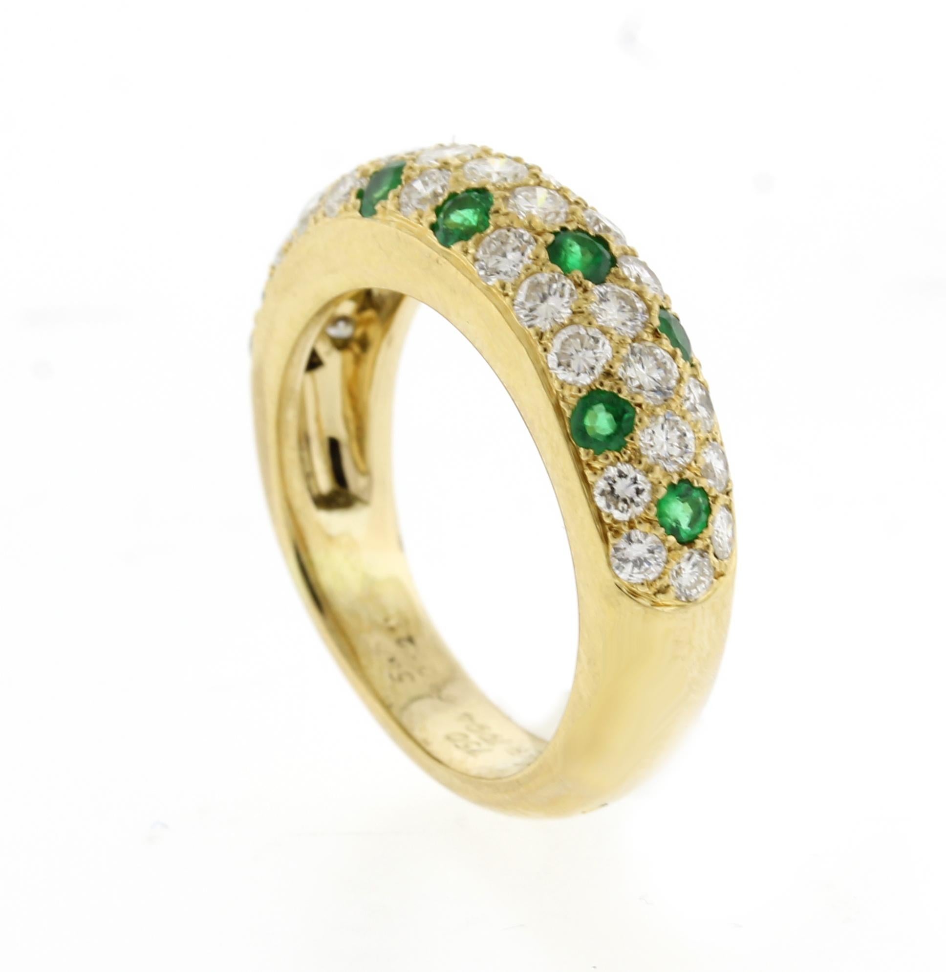 From Cartier's mimi collection of pave diamond and gemstone rings. This sophisticated diamond and vivid green emerald ring.  
• Designer: Cartier
•  18 karat gold
•  Circa:  Late 1990s
•  Size: 54  6 ¾ US
•  6.4mm wide tapering to 4.3mm
•  33