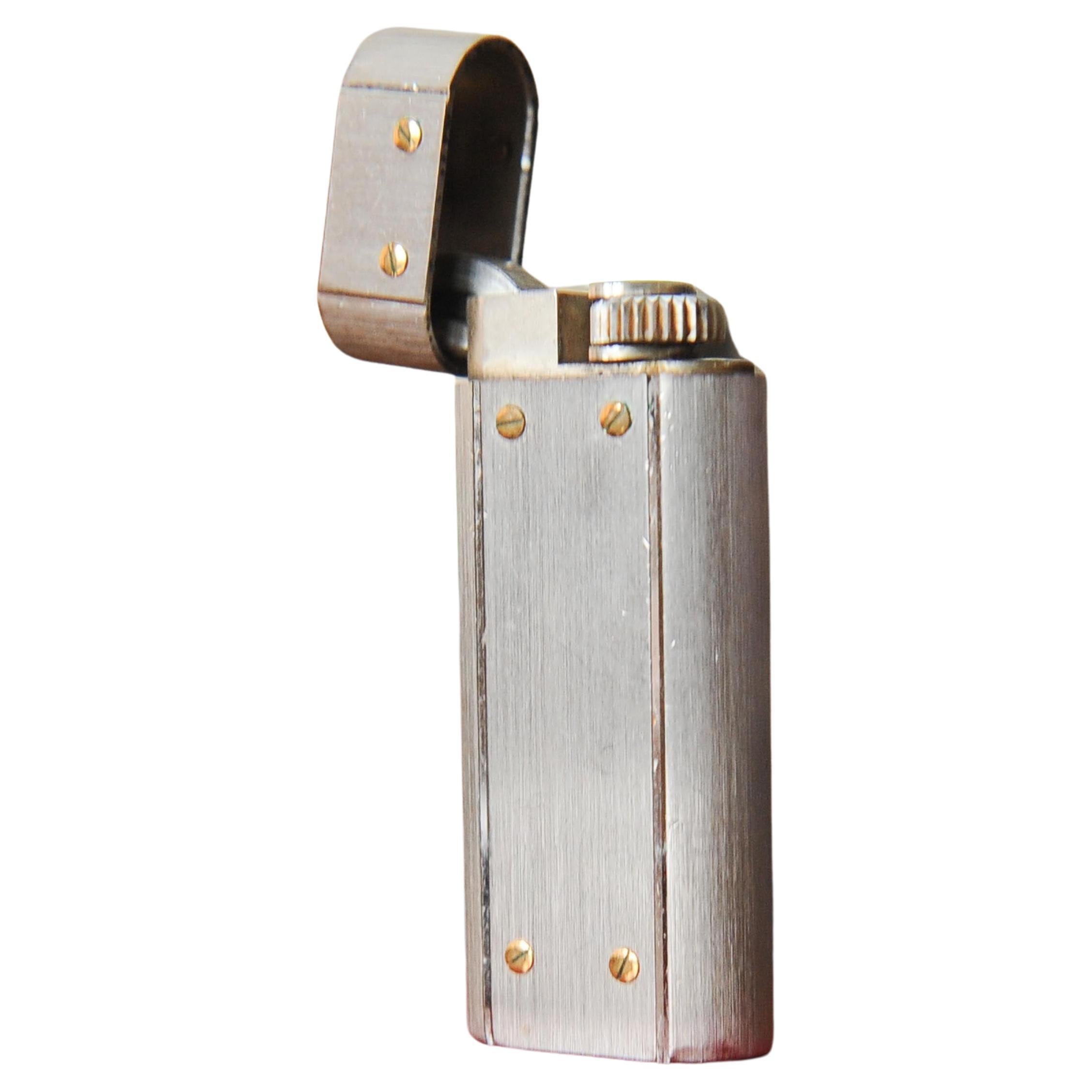 Cartier Mini Oval SG Santos Cigarette Lighter With Original Box & Paperwork Serial Ref E08911

Made in Paris, France

With original paperwork, & service booklet from 2001 stamped Bond Street, London. 

