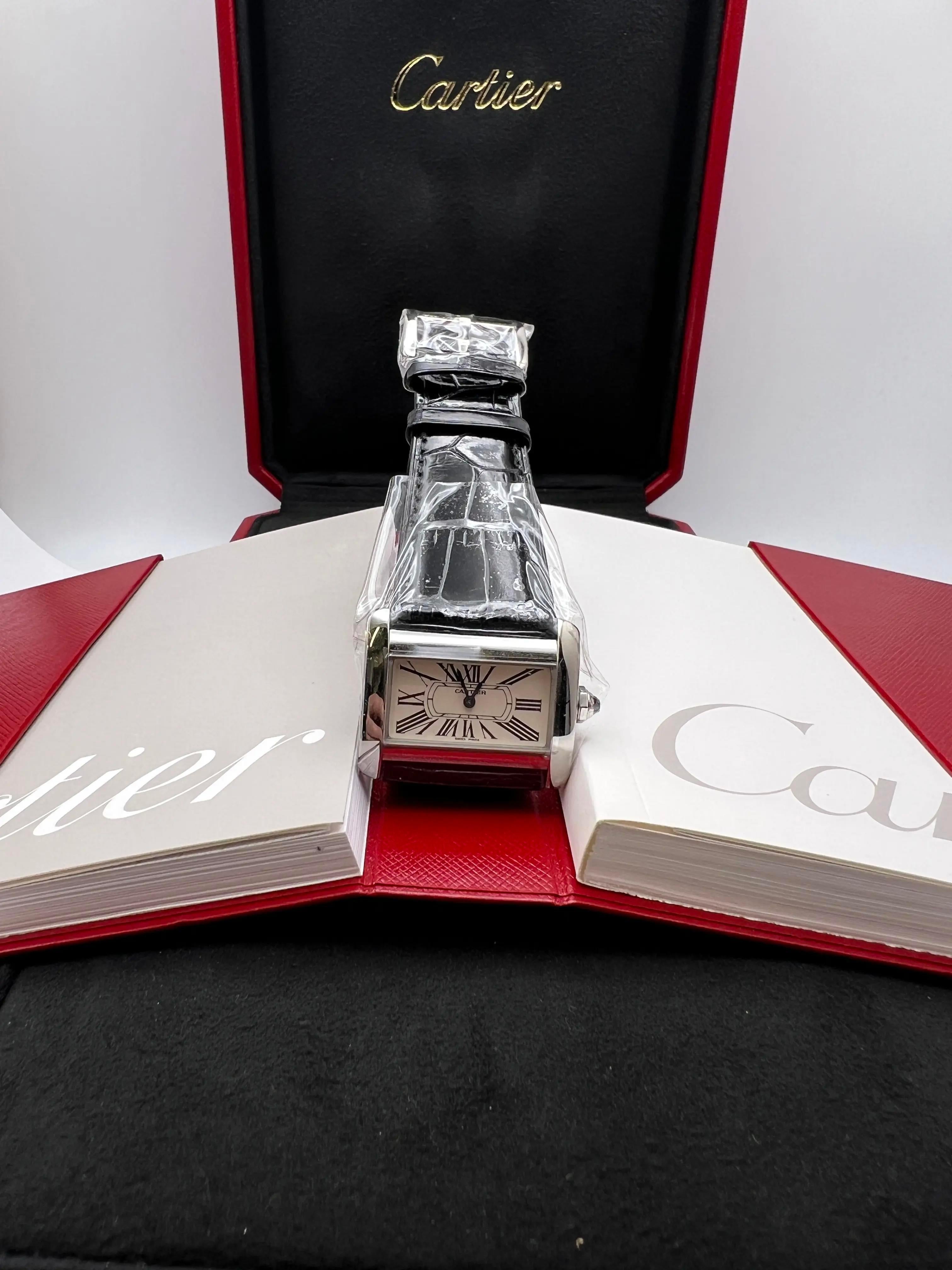 The Cartier Mini Tank Divan, reference W6300255, is a unique and elegant timepiece that showcases Cartier's iconic design with a modern twist. This model features a rectangular stainless steel case measuring 31.5 x 20mm with a polished finish,