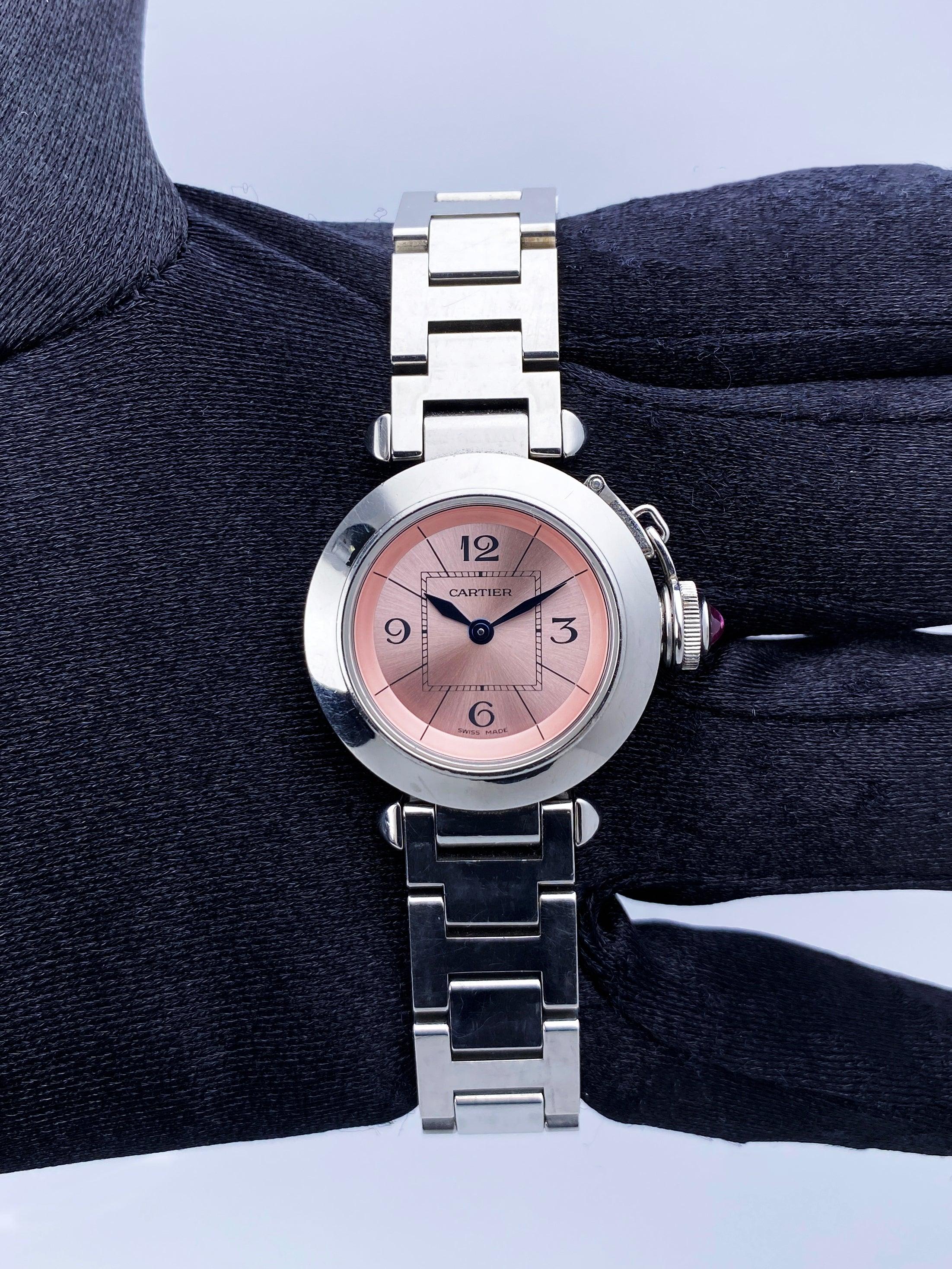 Cartier Miss Pasha 2973 Ladies Watch. 27mm stainless steel case with stainless steel smooth bezel. Pink dial with blue hands and Arabic numeral hour markers. Minute markers on the inner dial. Stainless steel bracelet with hidden butterfly clasp.