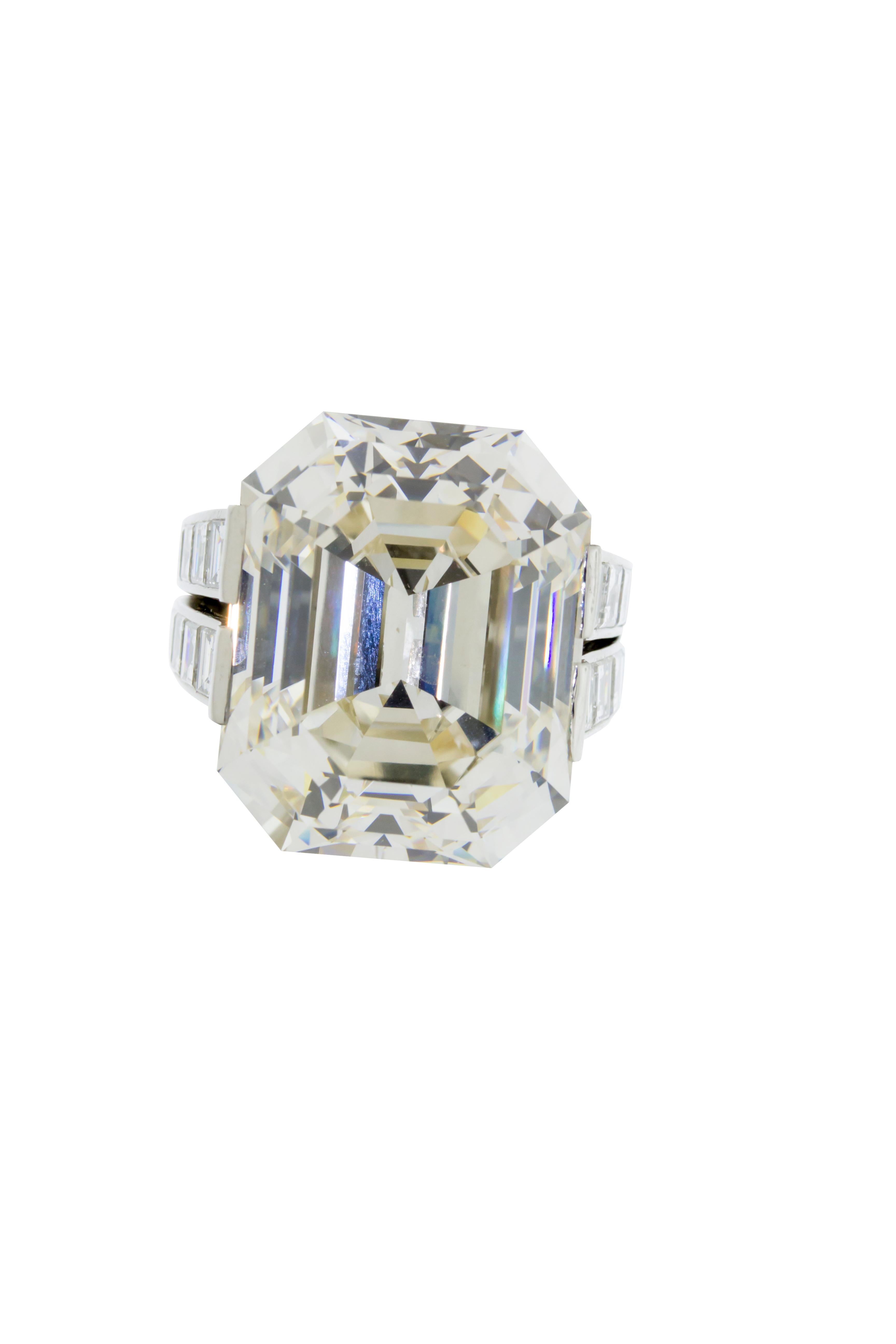 A 30.03 carat L Faint Brown VVS1 GIA certified emerald cut diamond set in an 18 grams of platinum signed by Cartier Monture. The setting features 28 baguette cut diamonds weighing 4.10 carats, and 65 round brilliant stones weighing 1.70 carats. This
