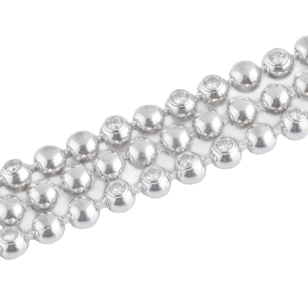 A beautiful 18k white gold choker necklace from the Cartier Moonlight collection. The necklace is composed of 3 strands featuring circular ball motifs, intermittently set with rub over set diamonds. The necklace has a total of 120 round brilliant