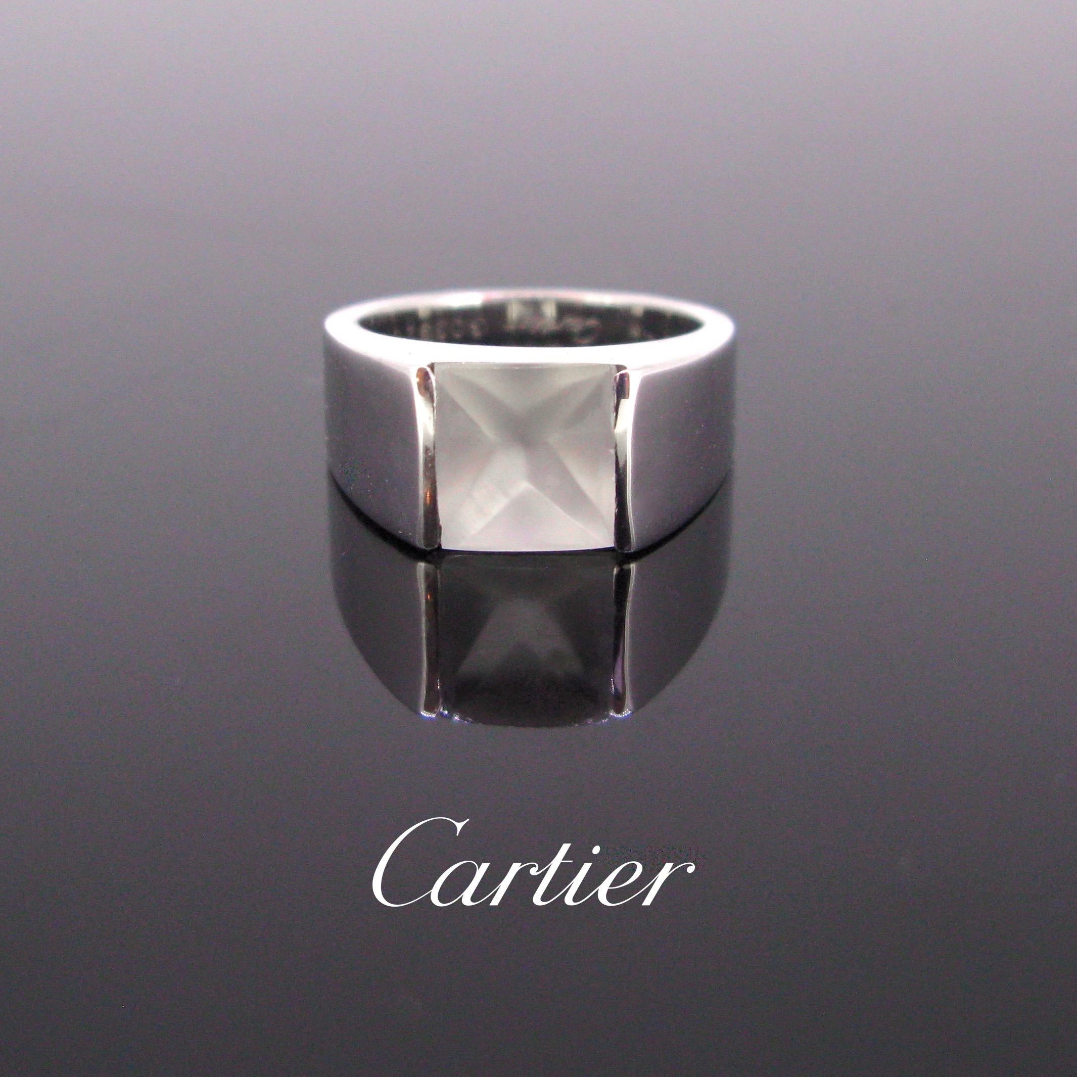 This Cartier ring is fully made in 18kt white gold. It is adorned with a Moonstone. The ring is from the Tank collection. It is signed and numbered inside the band. The ring presents few traces of wears however it in in very good vintage condition