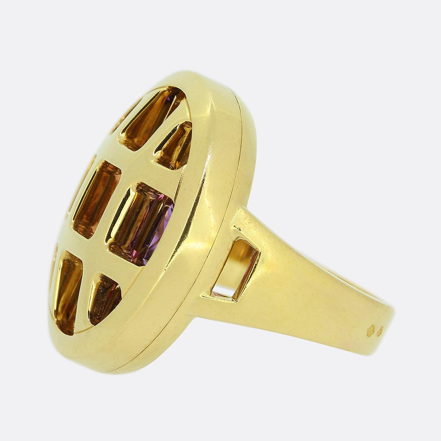 Here we have a fabulous multi gemstone ring from the world renowned luxury jewellery house of Cartier. A large rounded head has been crafted from 18ct yellow gold with square and triangular shaped openings playing host to matching sized gemstones