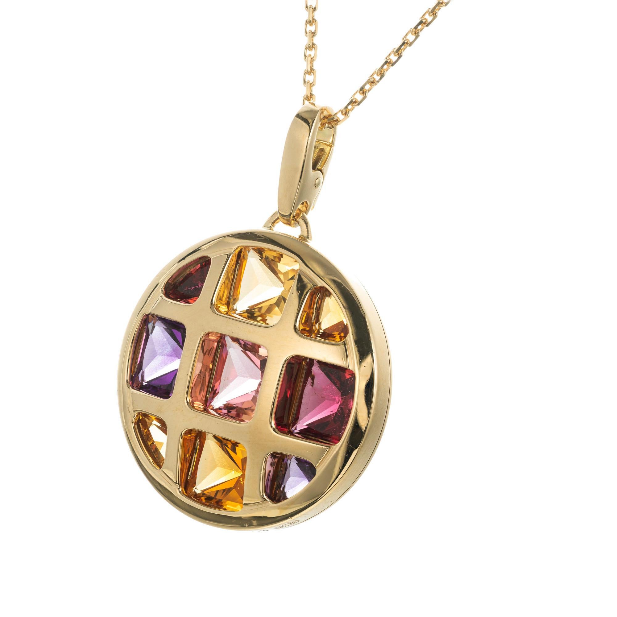 Cartier multi-gemstone pasha pendant enhancer in 18k yellow gold. 

9 Assorted multi-color custom cut gemstones 
18k yellow gold 
Stamped: Cartier 750
Hallmark: No. 7013
22.4 grams
Top to bottom: 39.63mm or 1.56 Inches
Width: 26.93mm or 1.06