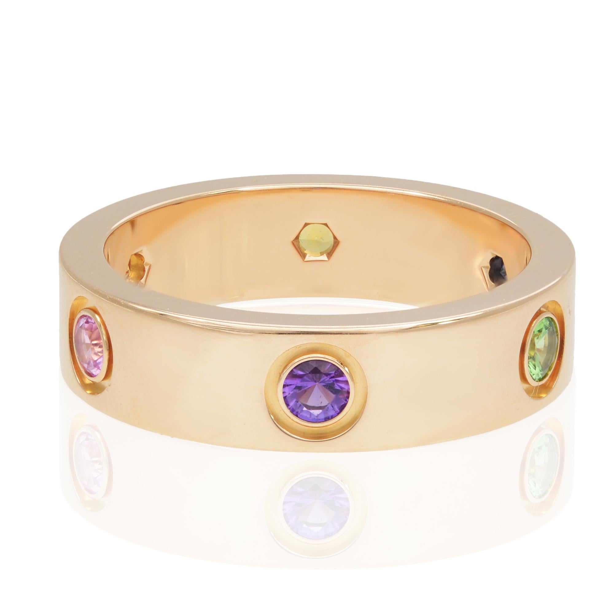 Cartier multicolor ring in 18K rose gold. Set with 1 rose sapphire, 1 blue sapphire, 1 yellow sapphire, 1 green garnet, 1 orange garnet and 1 amethyst. Width of the rings is 5.5mm. Ring size 57 US 8. Excellent pre-owned condition. Come with with