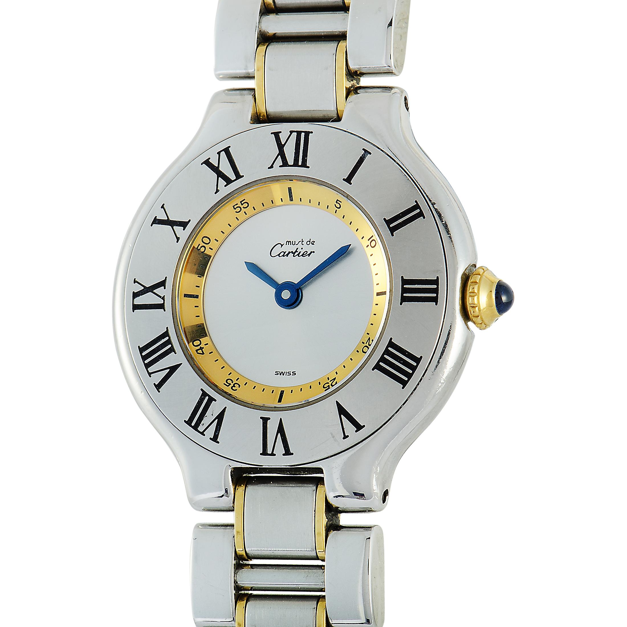 This is the Must 21 by Cartier, reference number 1340.

The watch boasts a water-resistant stainless steel case that is presented on a stainless steel bracelet. This model is powered by a quartz movement and indicates hours and minutes upon the