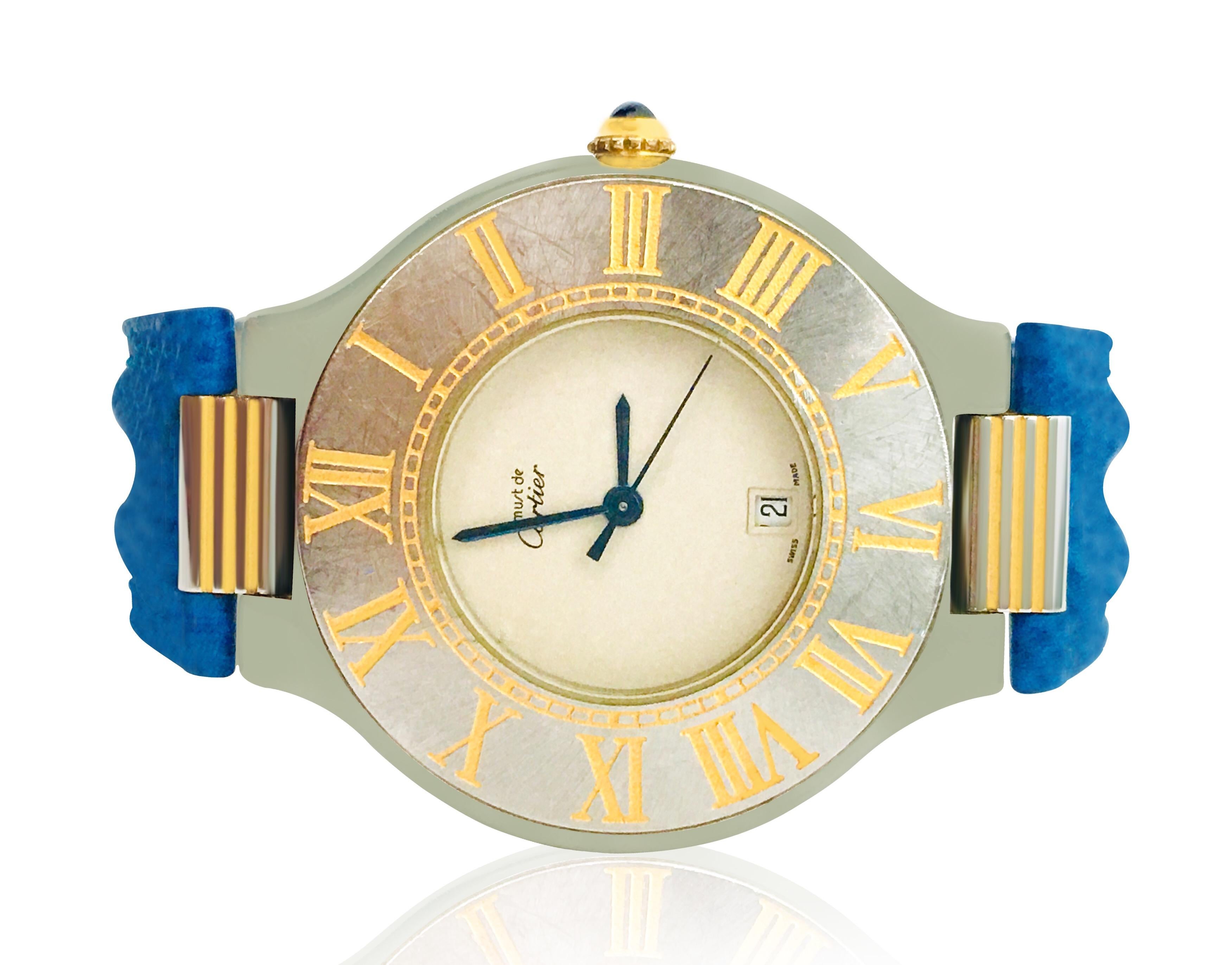 Brand: Cartier. 
Model: Must de 21 Cartier.
Steel and Gold. 
Roman dial in gold. Original Cartier leather band. 
Sapphire glass. 
Clasp: fold. 
Clasp material: stainless steel.
Diameter: 35mm. 
Watch comes with two bands, Azure blue color & deep