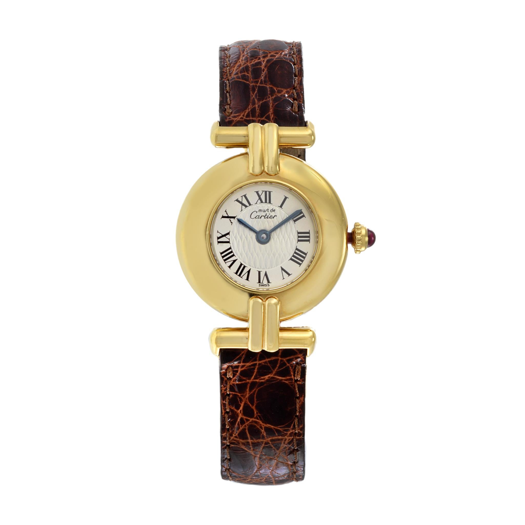 Dies ist eine limitierte Auflage der Uhr Must de Cartier Colisee. Das 24-mm-Gehäuse ist aus vergoldetem Sterlingsilber, das mit 18 Karat Gelbgold überzogen ist. Die Uhr wird von einem hochpräzisen Quarzwerk angetrieben. Sie ist an einem braunen
