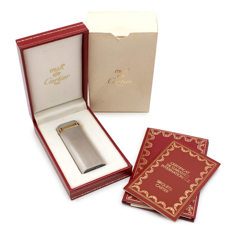 Cartier Must De Cartier Silver Plated Briquet Lighter

Brushed Silver Plated Finish
Gold plated trim 
Refillable with refill prong and instructions included
Cartier Box included
Certificate and Care Booklet included

Please note, these items are