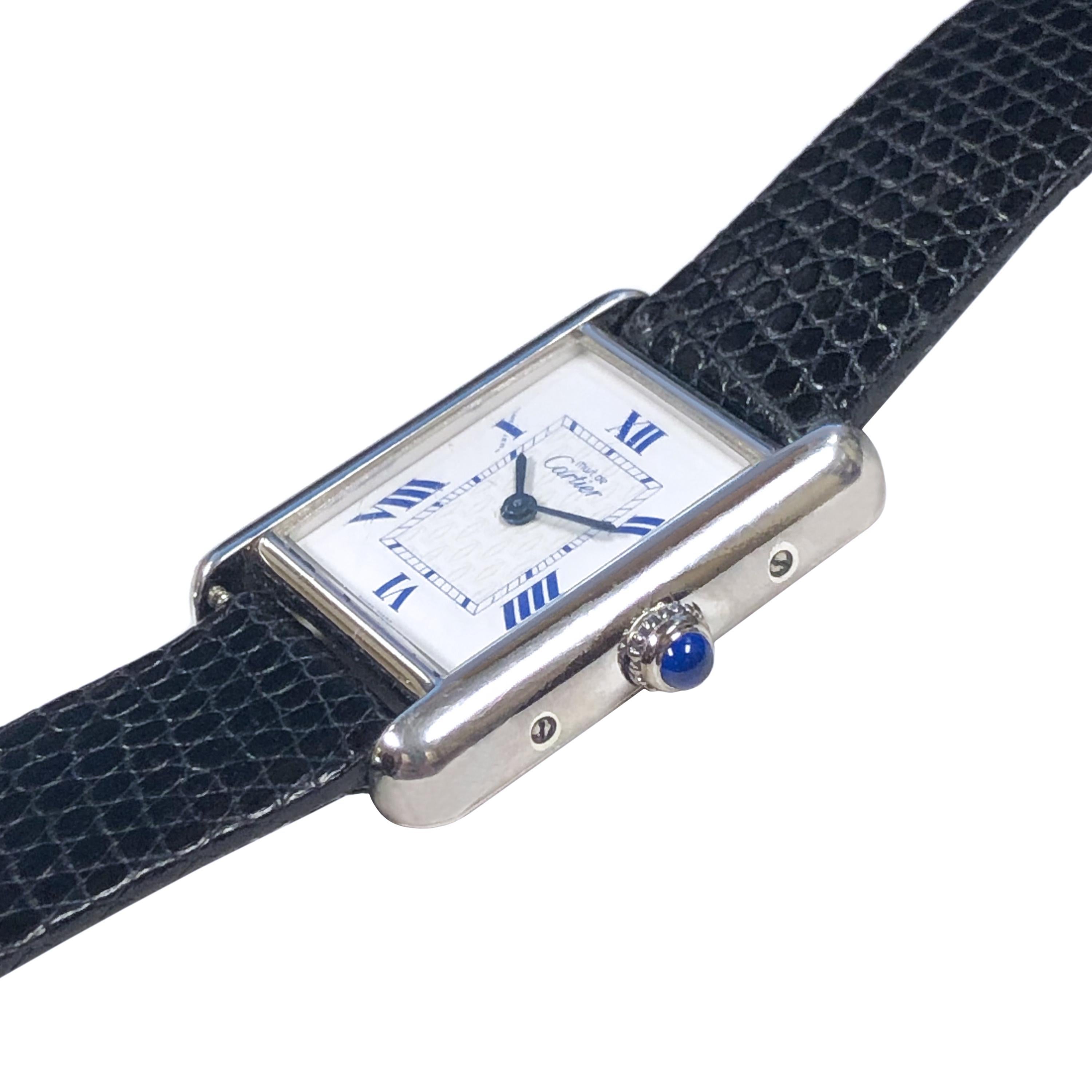 Circa 2000 Cartier, Must De Cartier Wrist Watch, 29 X 22 M.M. 2 piece water resistant Sterling Silver case. Quartz movement, White Dial with Blue Roman Numerals and Cartier CC logo center. New Black Lizard strap with original Silvered Tang Buckle.