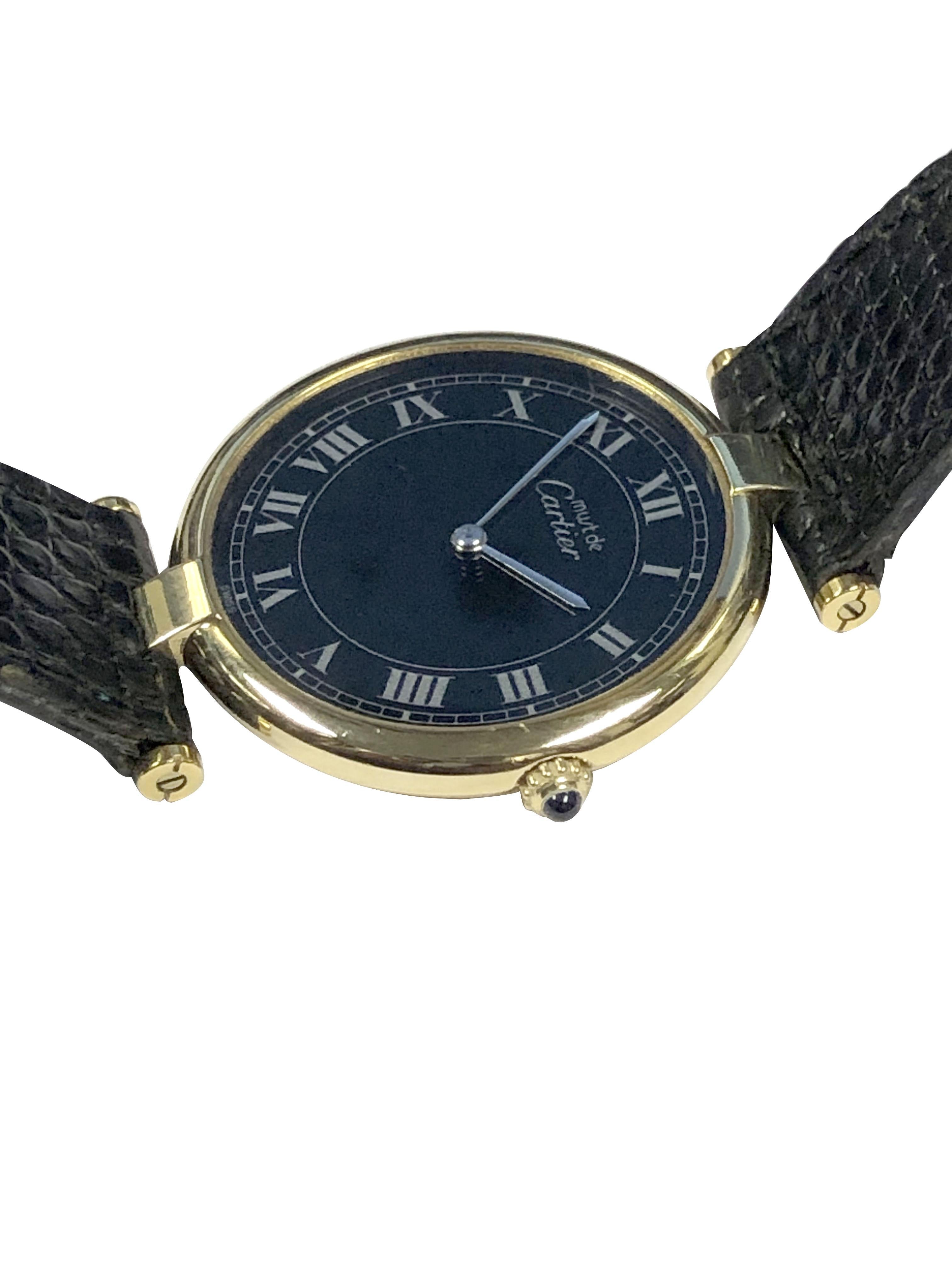 Circa 1980s Cartier, Must de Cartier Vendome Wrist Watch, 30 M.M. Vermeil ( Gold plate on .925 Sterling Silver ) 2 piece case. Quartz movement, Scarce Black dial with Silver Gray Roman numerals, Sapphire Crown. Original Black Lizard strap with