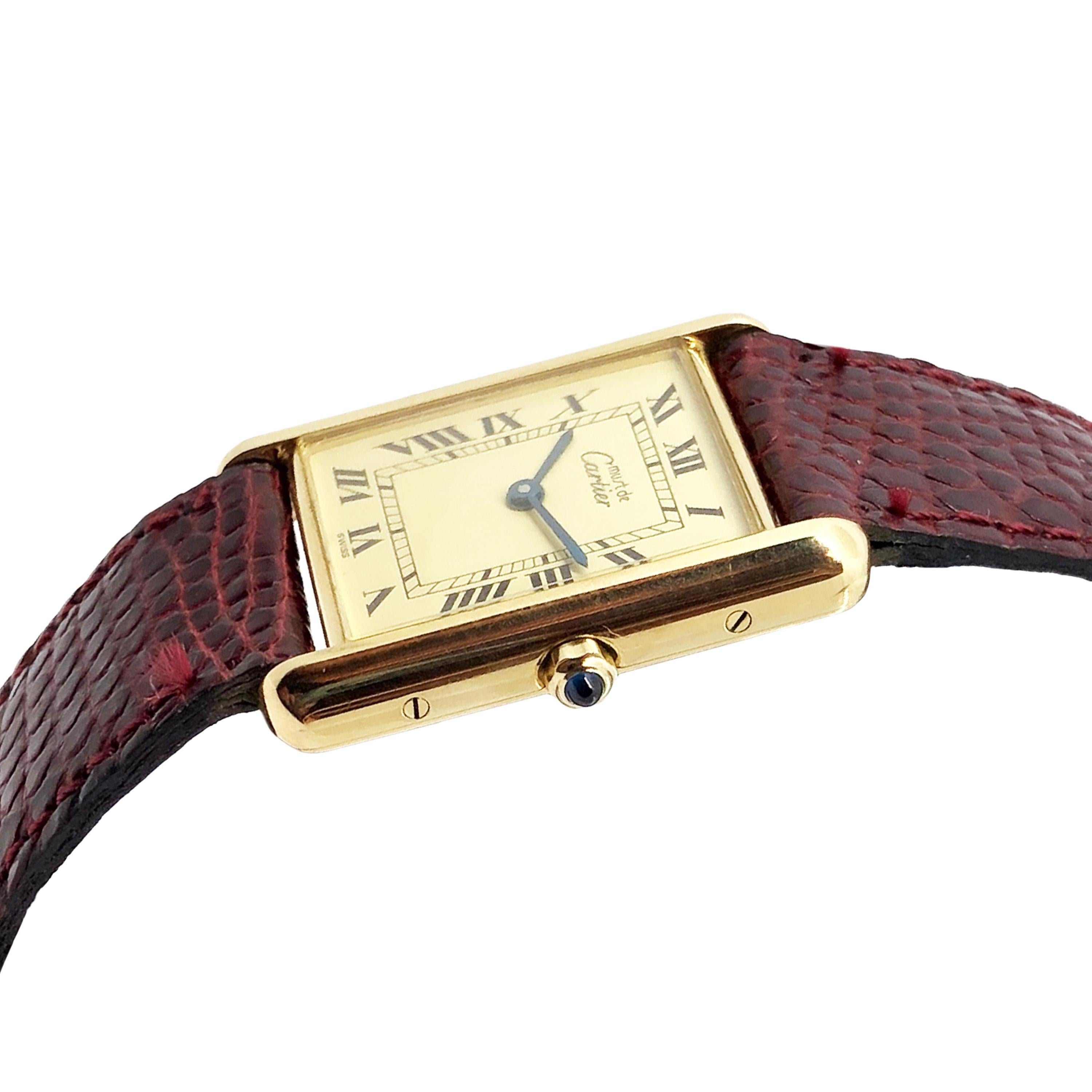 Circa 1990 Cartier Must De Cartier Standard Size Classic Tank Wrist Watch, 30 X 24 MM Vermeil ( Gold plate on Sterling Silver ) 2 Piece case. Cream dial with Black Roman Numerals, quartz movement, sapphire crown. Original Cartier Burgundy Lizard