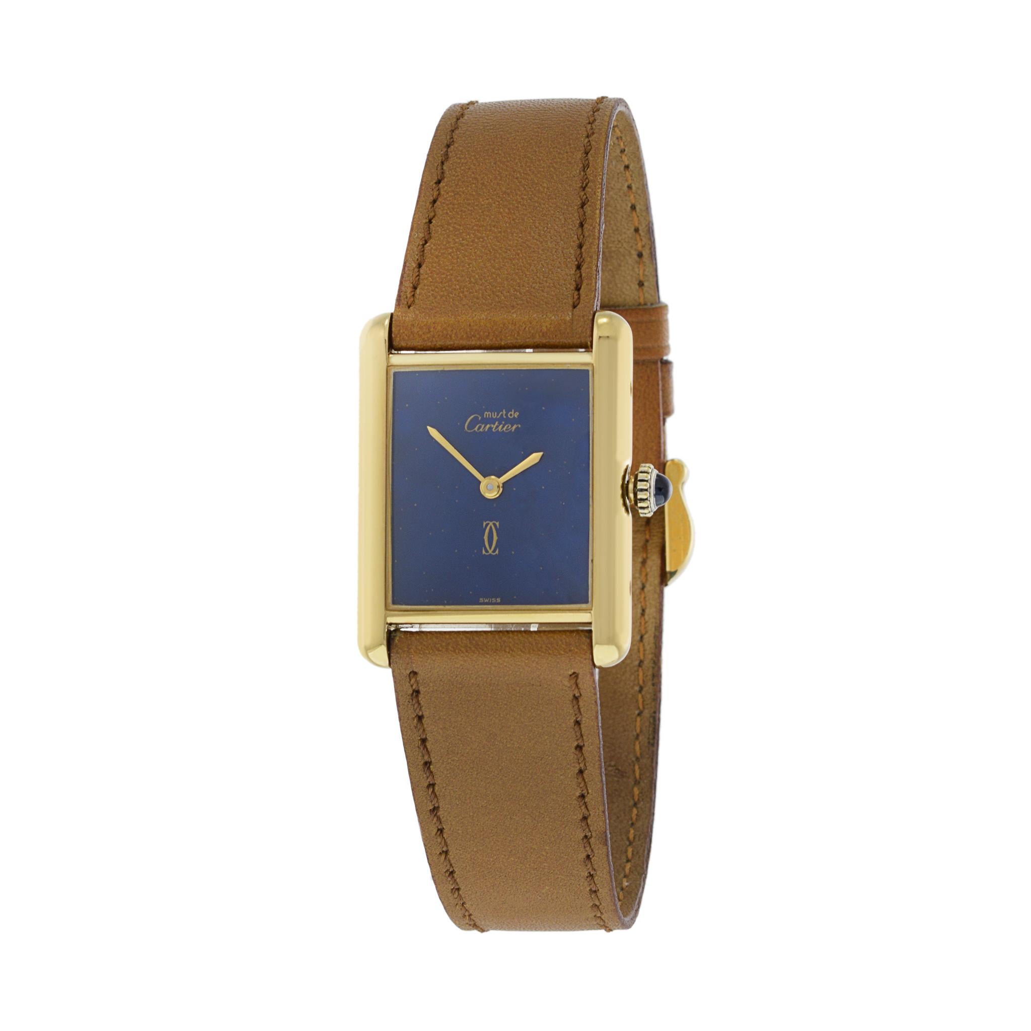 This is a beautiful mid size Cartier Must de Cartier vermeil tank watch. This watch is manually wound. The outstanding feature of this example is its real lapis stone dial. 

The case of this watch is 23.5mm x 30.5mm which is considered Cartier's