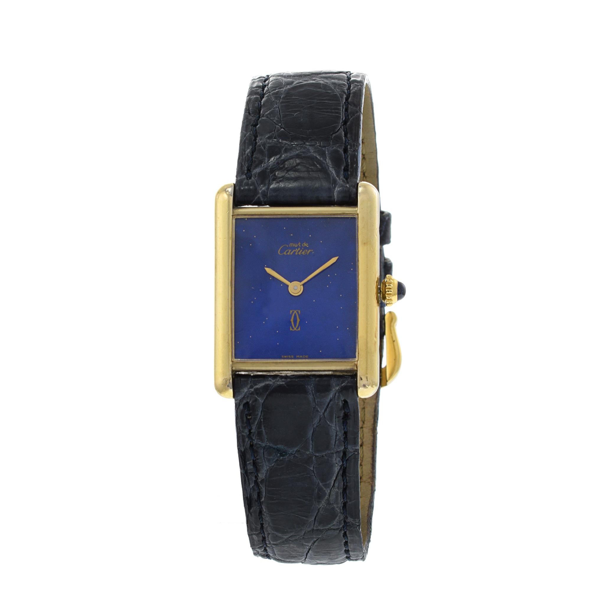 Introducing the Cartier Tank Vermeil Watch: Timeless Elegance.

Embrace refined luxury with the Cartier Tank Vermeil Watch. This iconic timepiece from the 1970s boasts a black dial, radiating timeless sophistication. The 23.5mm x 30.5mm dimensions