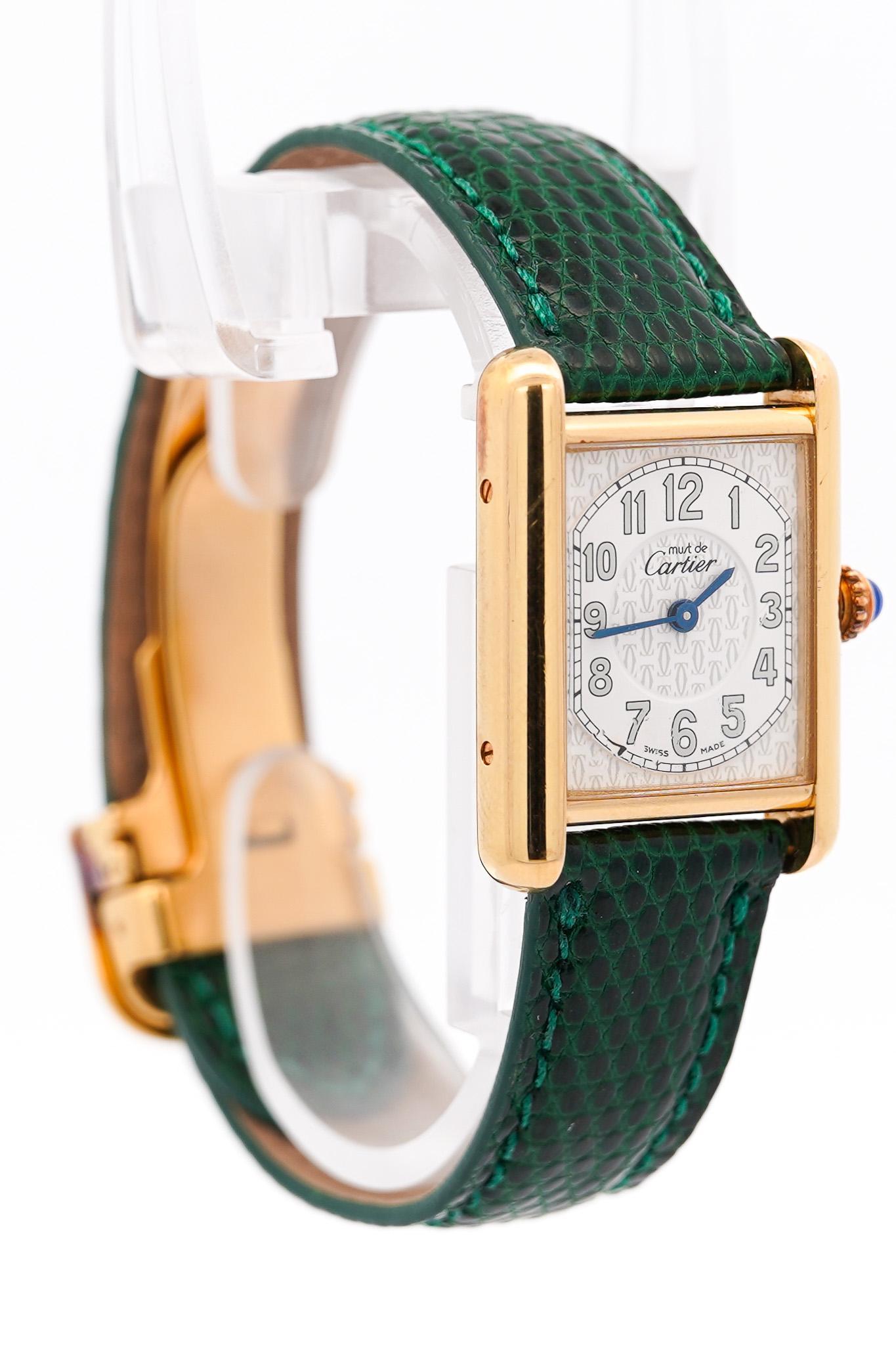 Cartier Tank 2415. Comes with the original box, papers, and an extra black Cartier leather strap. 925 Silver base with 18K gold plating, Embossed white dial with Arabic index blue hands, Rare Cartier logo imprinted throughout the dial.

- Brand: