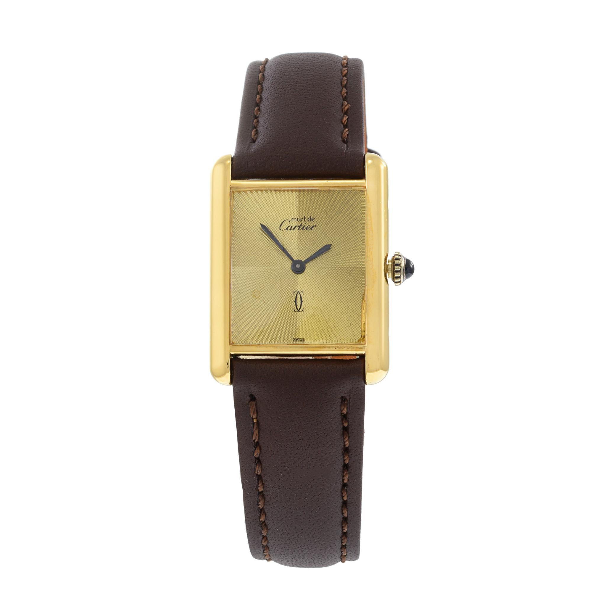 This is a rare 1980's Must de Cartier vermeil manual wind tank watch. The dial is a sunburst guilloche design which is rarely seen on these models. The case measures 23.5mm x 30.5mm and is solid sterling silver overlayed with 18K yellow gold. This