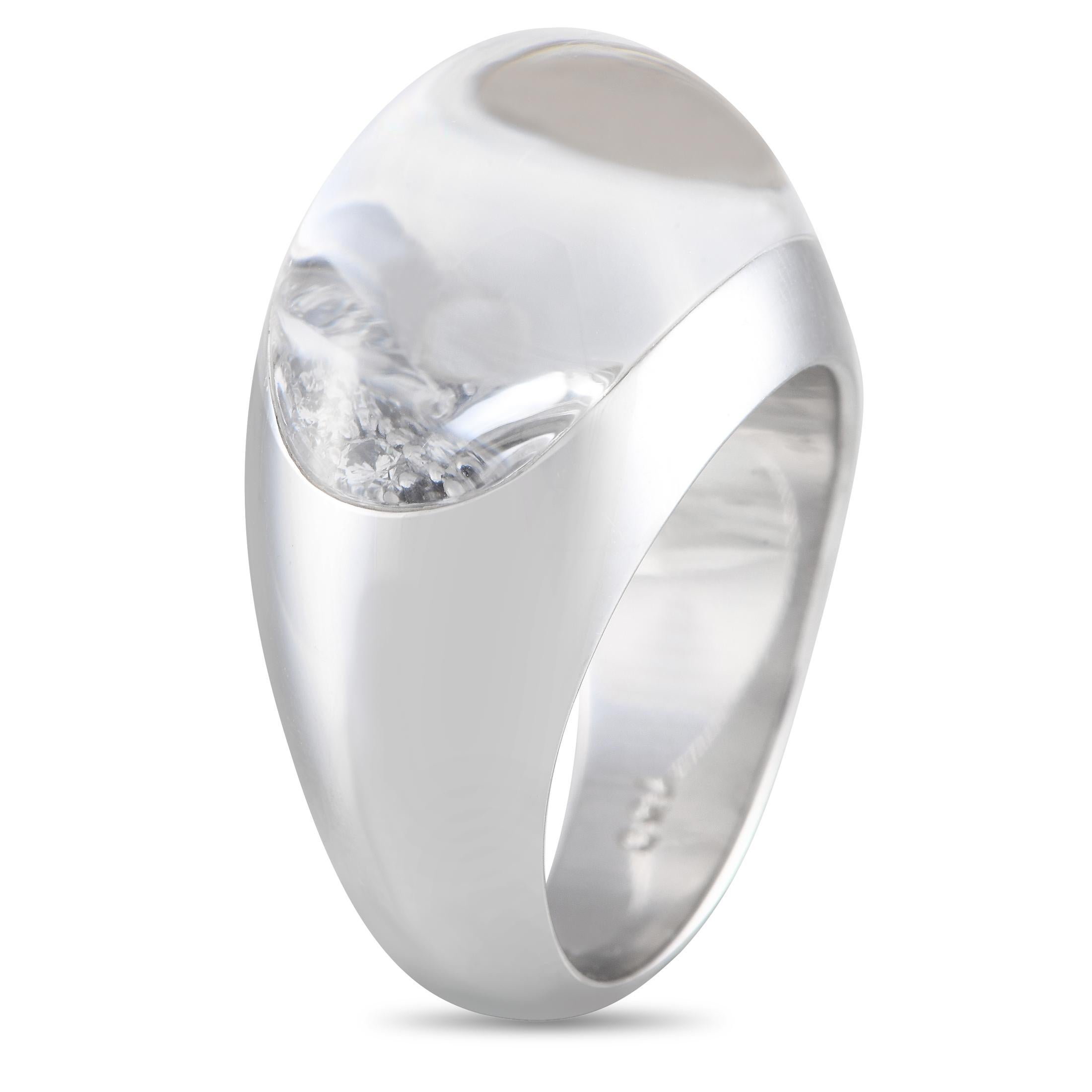 On this 18K white gold Cartier ring, a beautifully rounded rock crystal magnifies the 1.0 carats of sparkling diamonds accenting the center of the design. This piece features a 6mm wide band and a top height measuring 9mm.This jewelry piece is