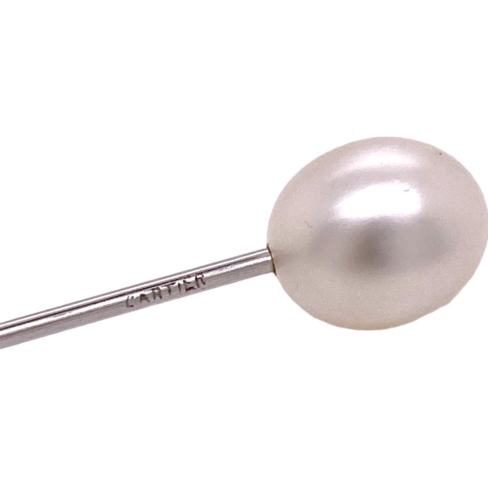 Rare vintage natural pearl stick pin by Cartier. The oval white natural pearl measures 10.7 x 9.0 mm and is certified by the GIA. The platinum stick pin measures 3.0 inches in length and is signed Cartier. 