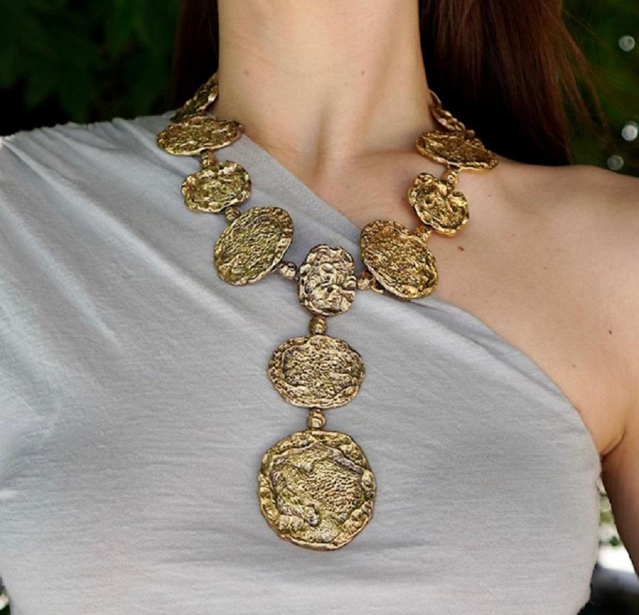 A Cartier gilded sterling silver (also called gold plated silver) nugget necklace.
This striking statement piece features an array of organic, textured silver nuggets. Each link gilded in gold, giving the piece a natural yet luxurious appearance.