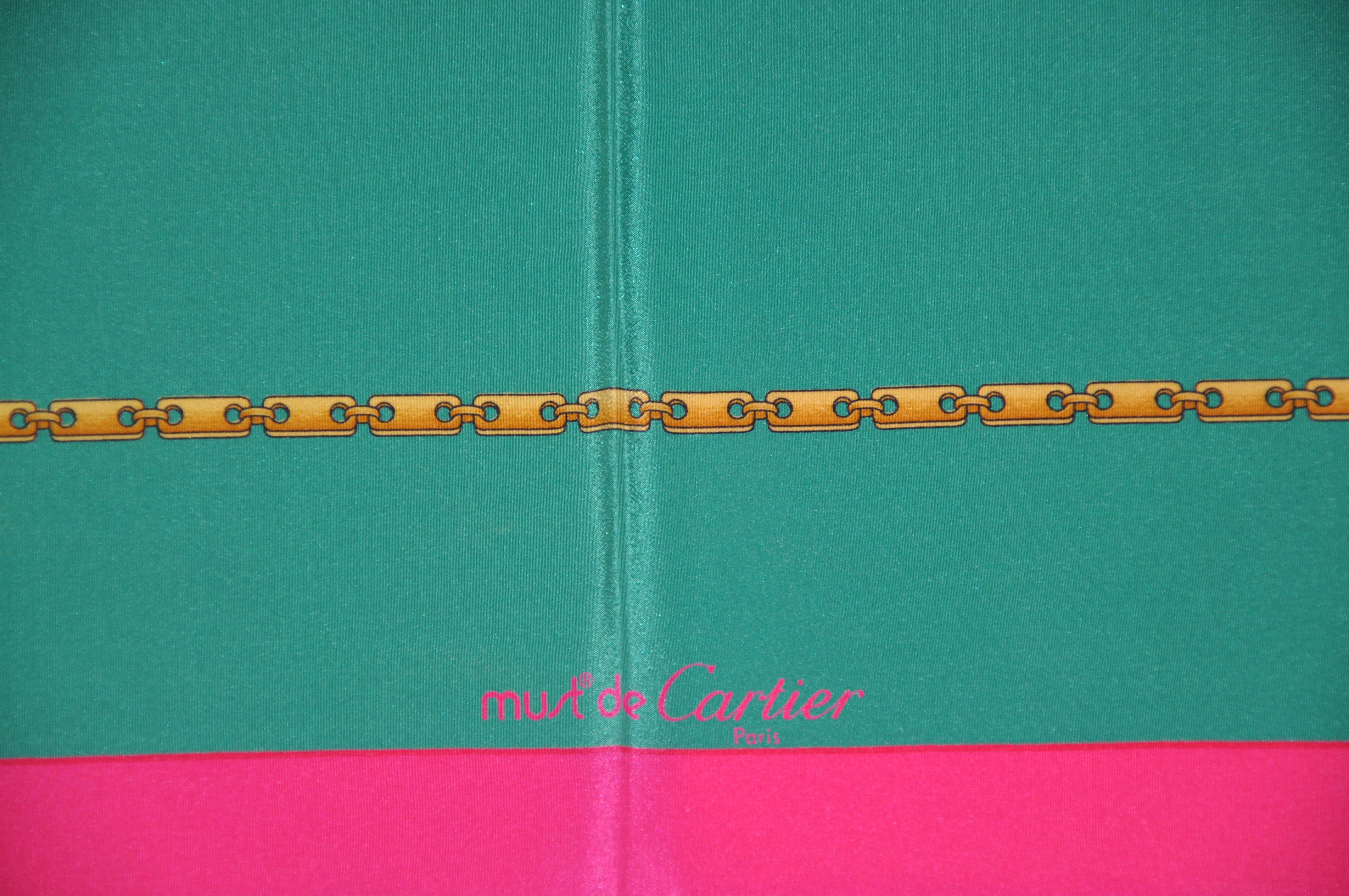     Cartier's Rich neon fuchsia borders surrounding aqua-green chain-link silk crepe di chine scarf accented with hand-rolled edges, measures 32 inches by 33 inches. Made in France.