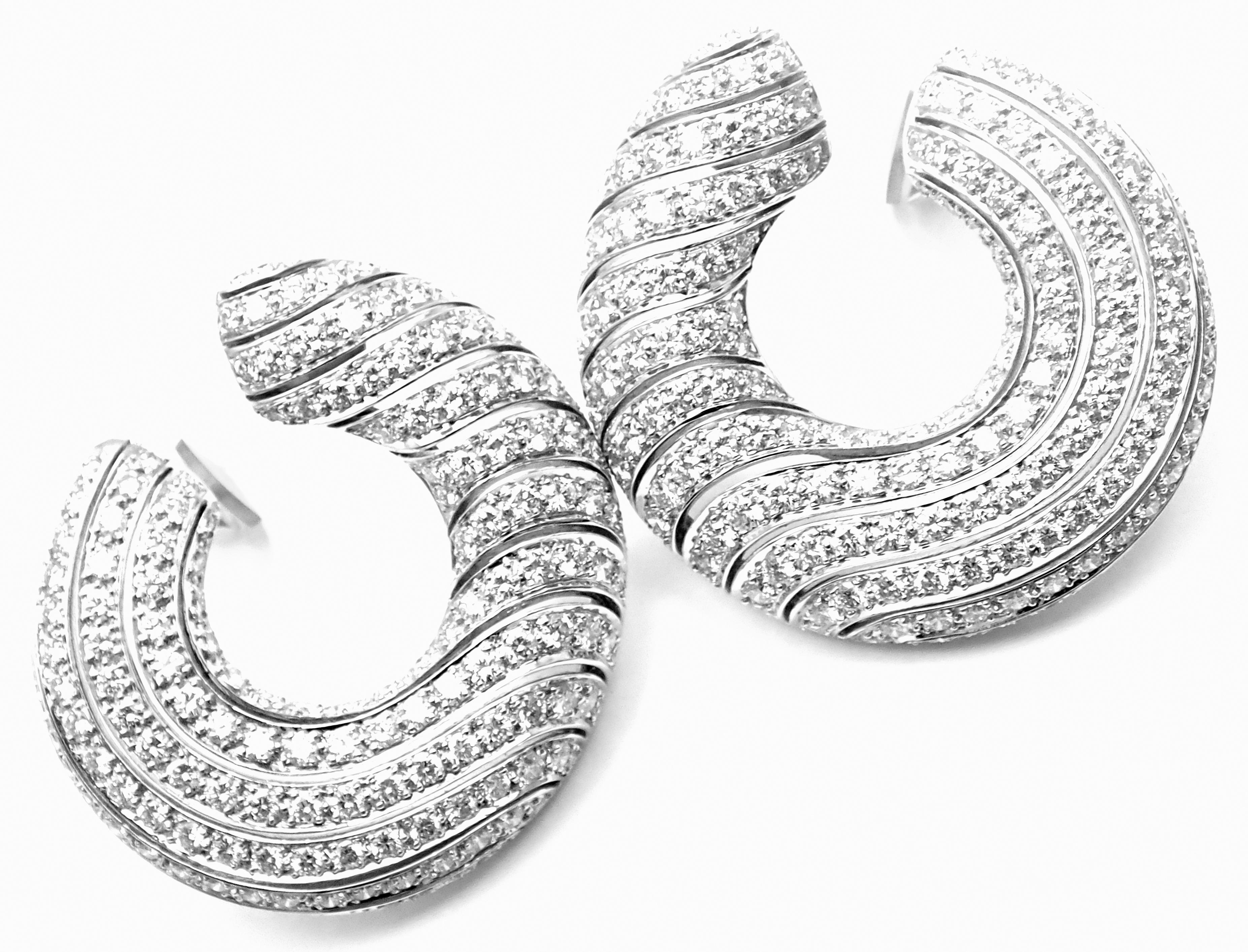 18k White Gold Diamond Neptune Hoop Earrings by Cartier. 
With Round brilliant cut diamonds total weight approx 6.15ct. 
Diamonds VVS1 clarity, E color
These earrings are in mint condition and come with service paper from Cartier NY.
***Earrings are