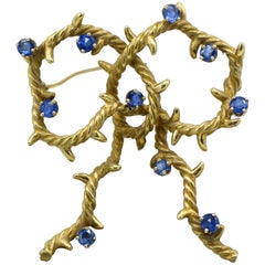 Cartier, New York 18 Karat Gold and Sapphire Bow Shaped Brooch