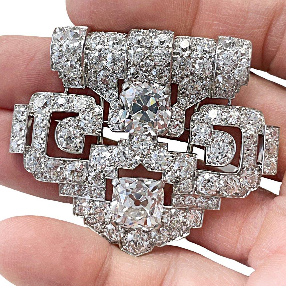 Magnificent Cartier Art Deco Platinum and Diamond Brooch featuring a matching pair of important Old Mine Cut Diamonds weighing 5.60 carats and 5.64 carats. Both accompanied by a GIA report stating that they are H color VS1 and H color VS2 clarity.