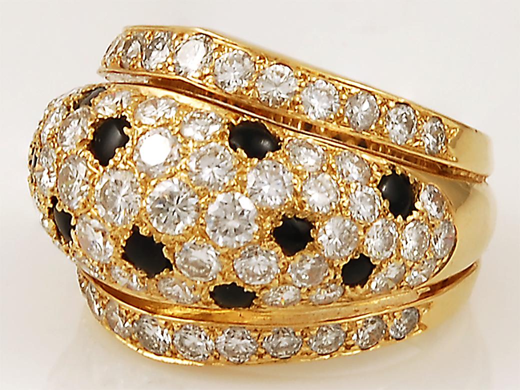 A resplendent ring by Cartier of bombe design, crafted with round brilliant cut diamonds enhanced with irregular shaped black onyx ‘spots’ to represent panthers skin. The iconic Panthère de Cartier represents beauty, strength, and timeless elegance.