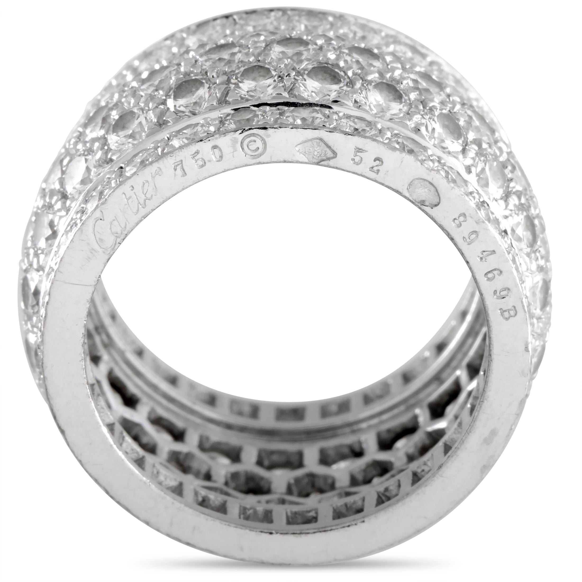 The Cartier “Nigeria” ring is made out of 18K white gold and diamonds that amount to approximately 5.00 carats. The ring weighs 11.4 grams and boasts band thickness of 12 mm and top height of 3 mm, while top dimensions measure 12 by 22 mm.

This