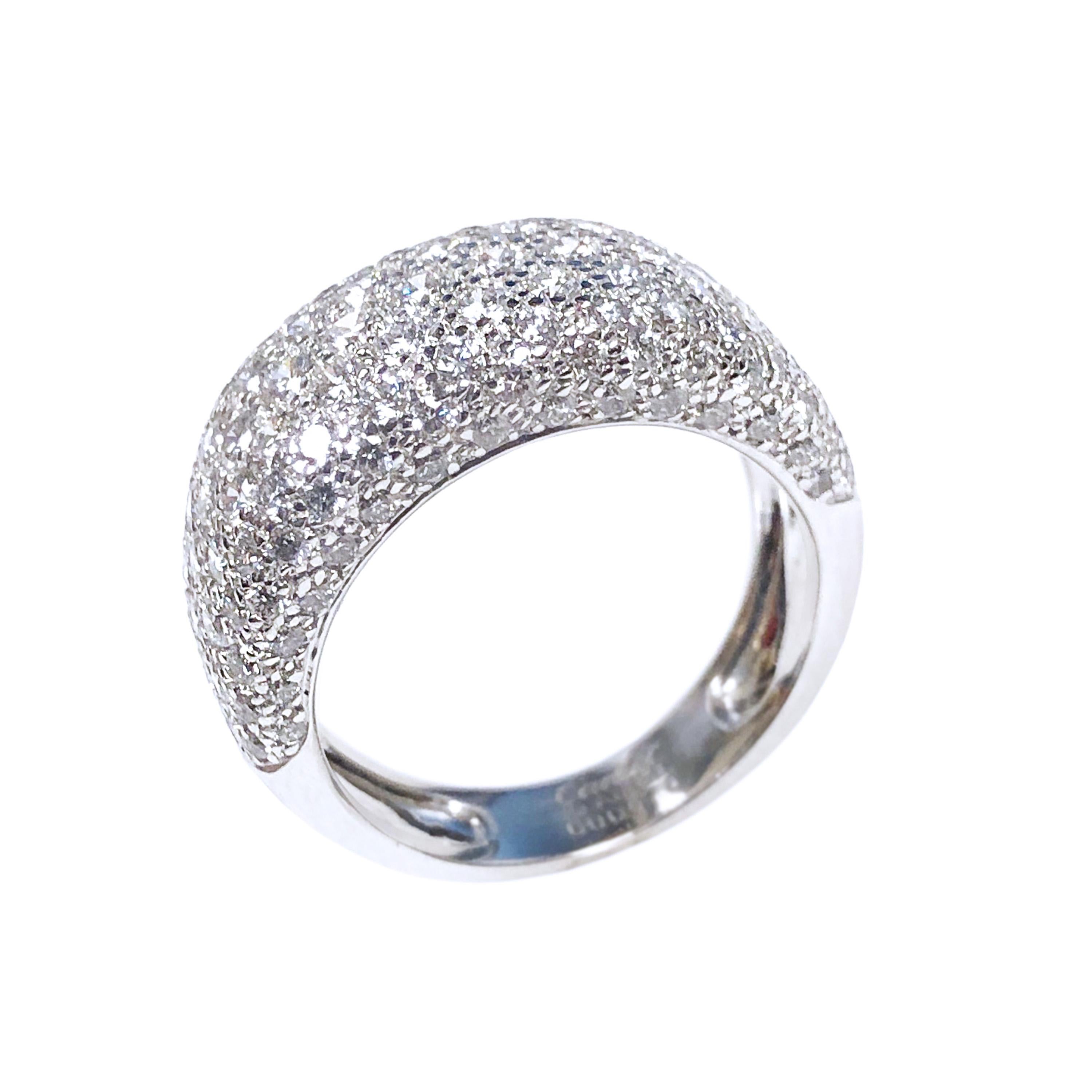 Circa 2005 Cartier Nouvelle Vague 18K White Gold Ring, in a Dome form and measuring 7/8 inch in length across the top and 3/8 inch wide. Pave set with 133 Round Brilliant cut Diamonds totaling 2.41 Carats and grading as F - G in Color and VS in