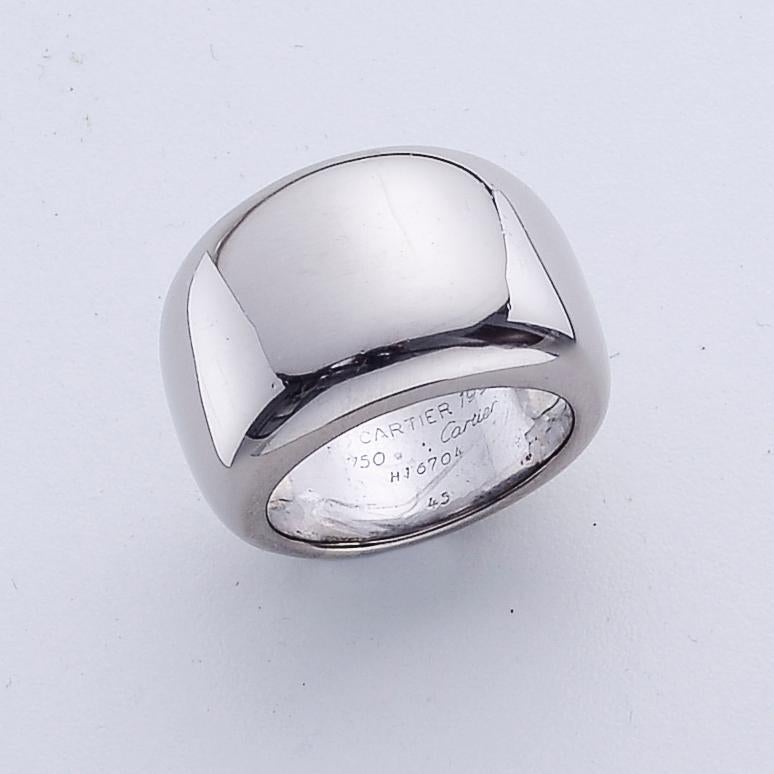 This bold Cartier ring from the Nouvelle Vague collection, is crafted in solid 18k white gold with a high polished finish and boasts a rounded dome profile. The piece is engraved with Cartier's signature, serial number and metal content. This ring