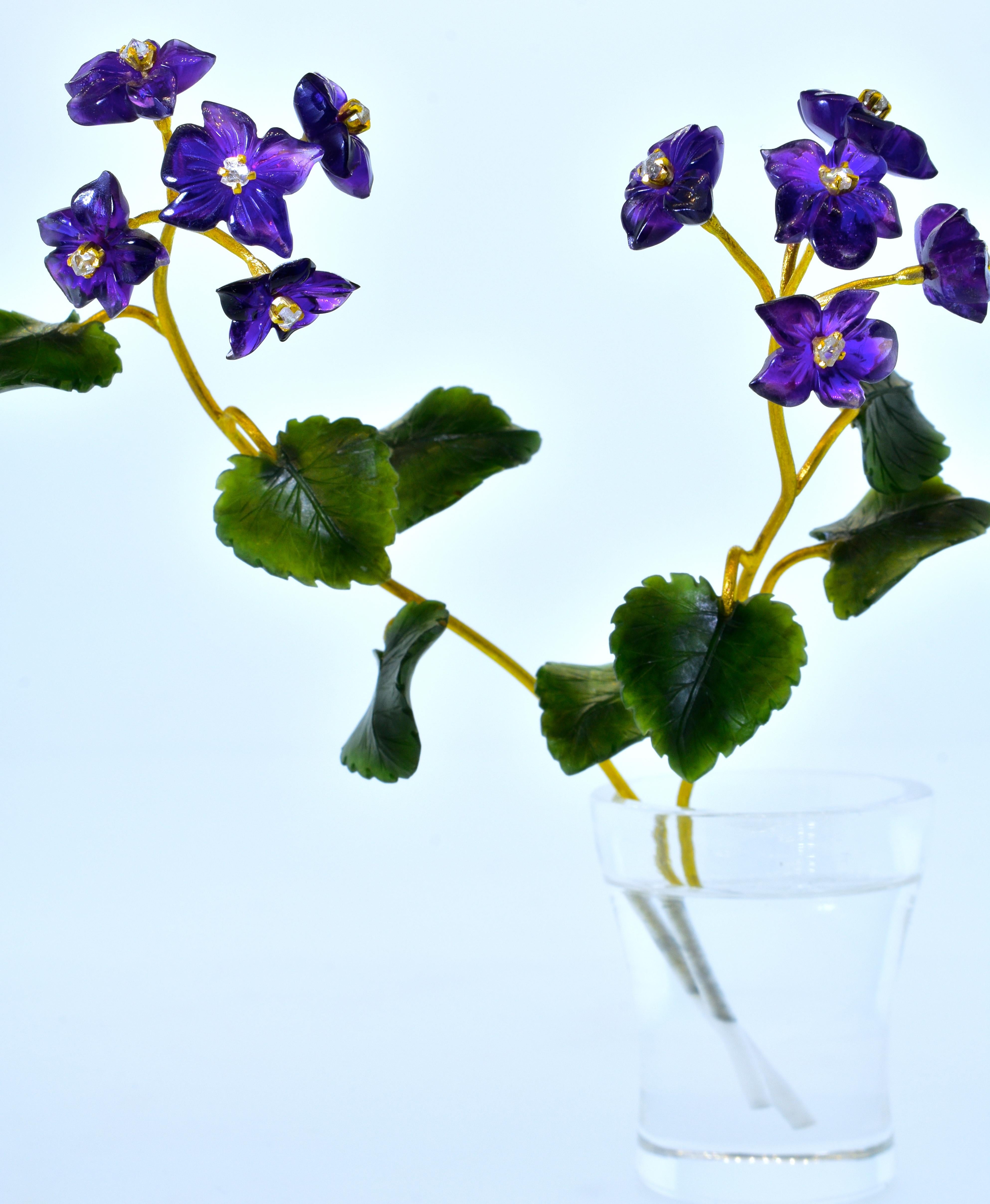 Cartier objet d'art.   A pair of freshly plucked Russian violets are placed in a shot glass of water.  In reality, the stems are 18K gold, the leaves are precisely carved Nephite (a customary hard stone), and a single amethyst depicts each 5 petaled