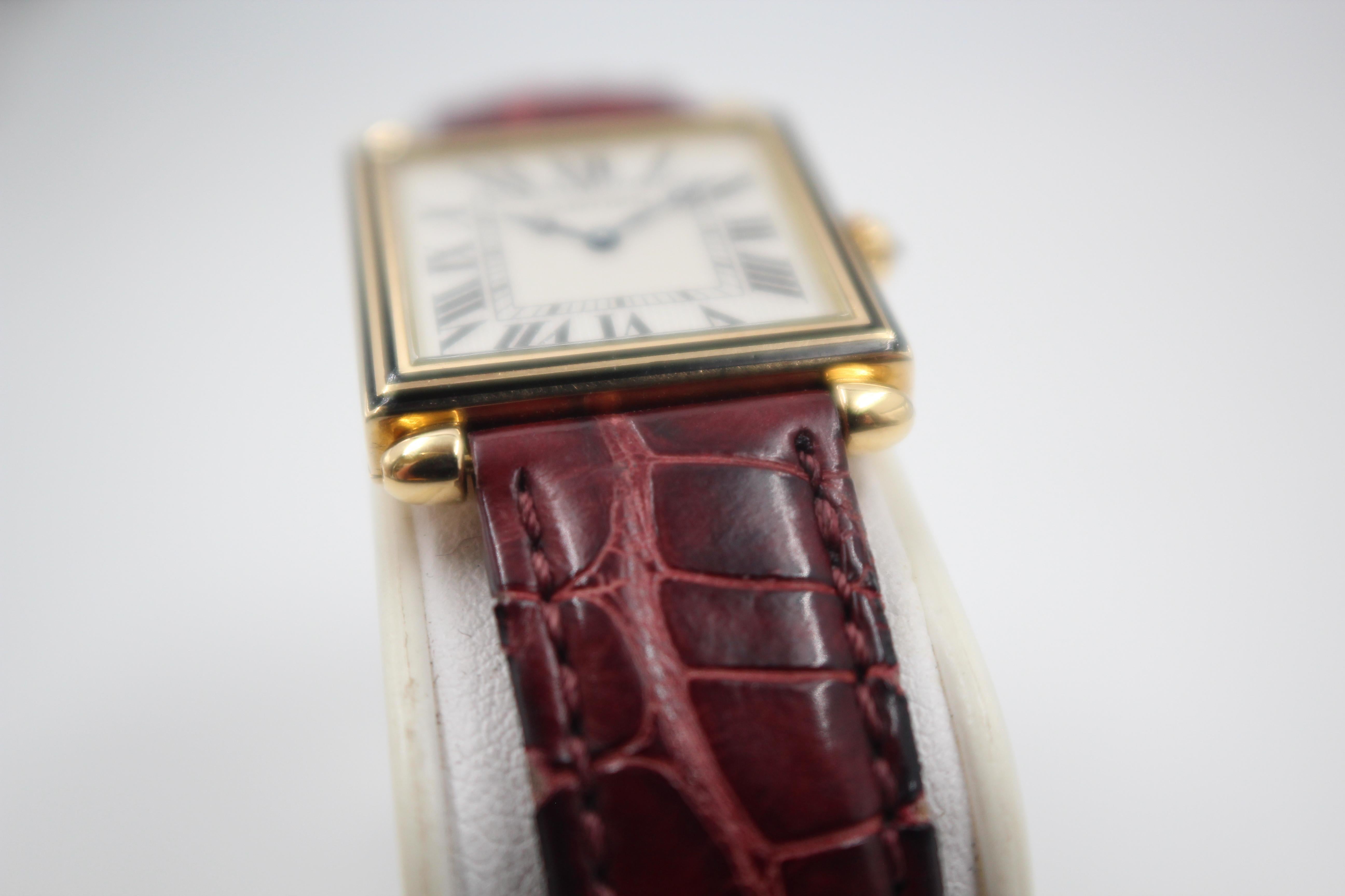 Pre-Owned 1990s Cartier Obus Carree, watch in 18K yellow gold with an enamel ring and white dial. Case measures 24mm, Cartier quartz movement. Original Cartier strap with a Panthere style clasp, ADB Strap measures 8