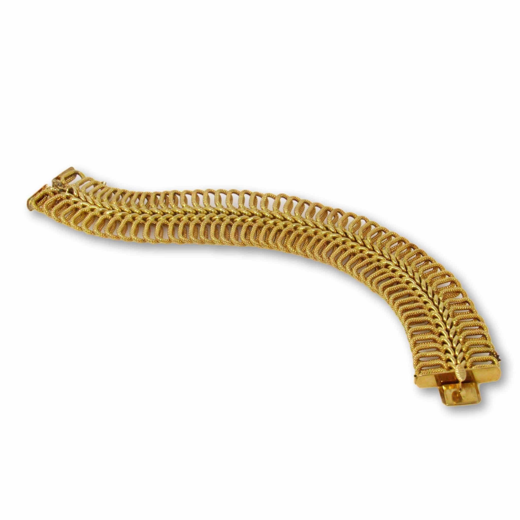 Textured Cartier of Italy bracelet that is constructed of 18k yellow gold

Ribbed design that creates unusual movement

7” long and 15/16