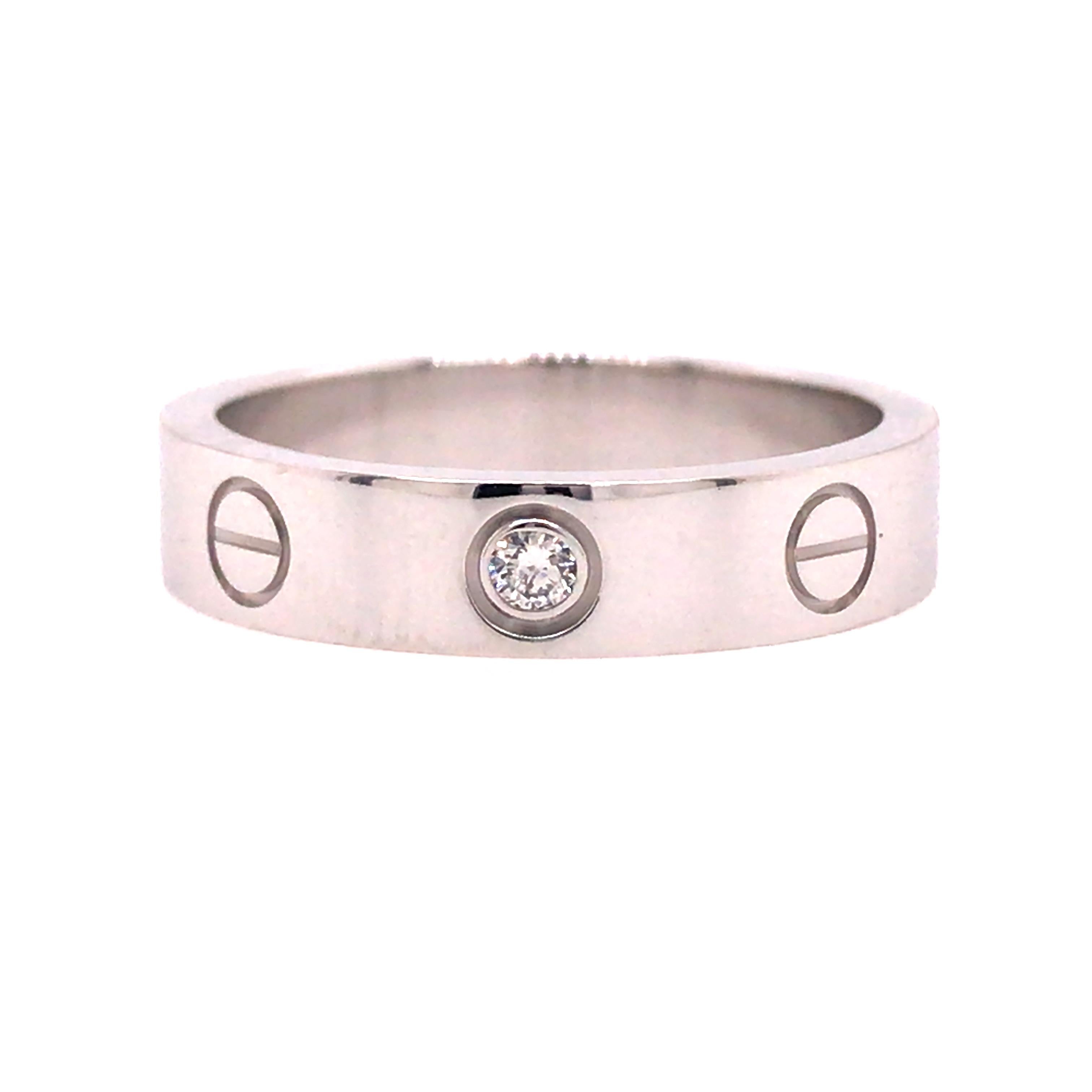 Cartier One Diamond Love Ring in 18K White Gold.  (1) Round Brilliant Cut Diamond weighing 0.02 carats is expertly set. The ring measures 4mm in width.  Ring size 4 3/4.  Stamped 