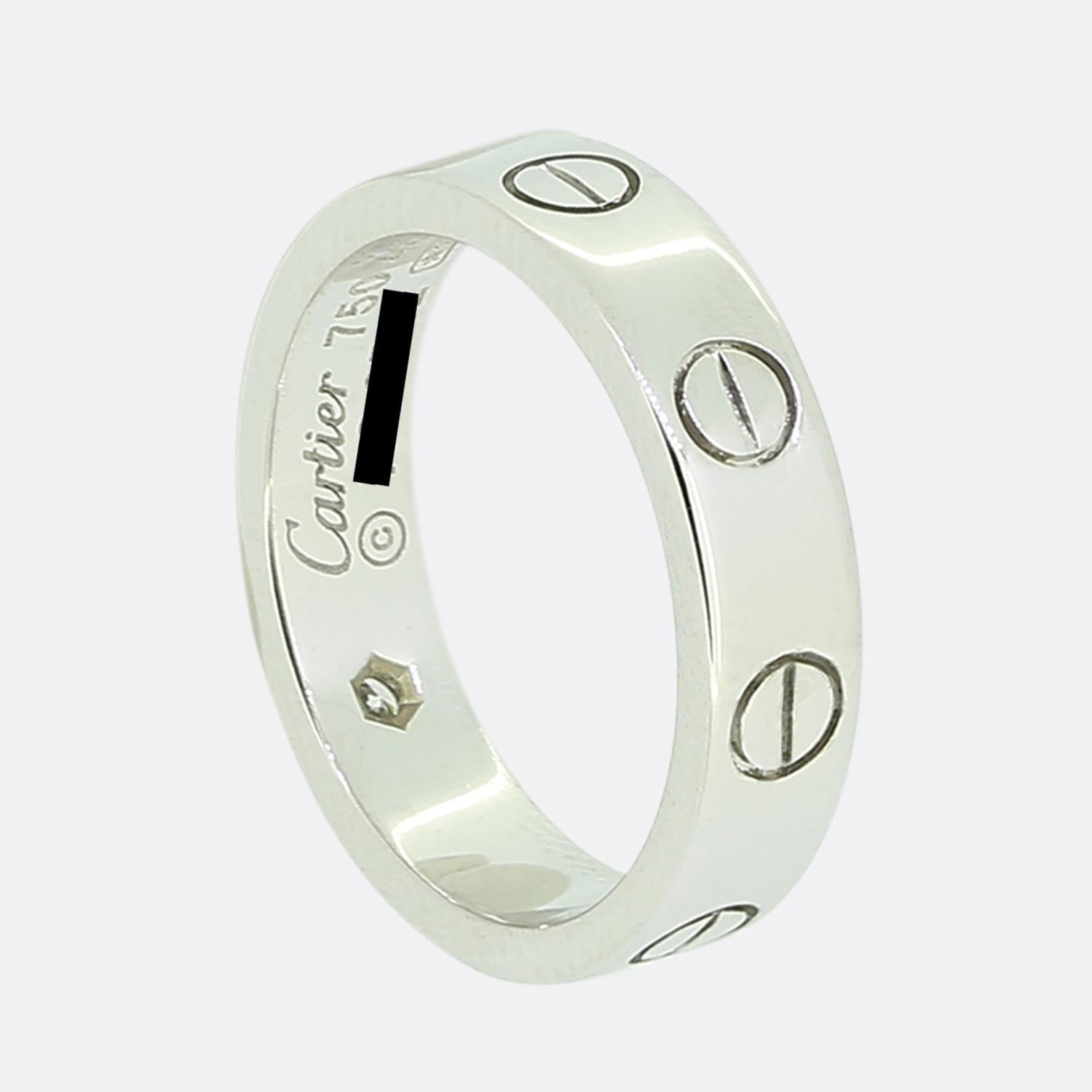 Here we have an 18ct white gold wedding ring from the luxury jewellery house of Cartier. This ring forms part of the world renowned LOVE collection and showcases a single round brilliant cut diamond alongside their iconic screw motif. This piece is