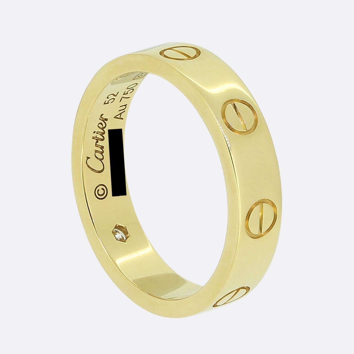 Here we have an 18ct yellow gold band ring from the world the renowned luxury jewellery house of Cartier. This ring forms part of their LOVE collection and showcases a single round brilliant cut diamonds alongside the iconic screw motif. This ring