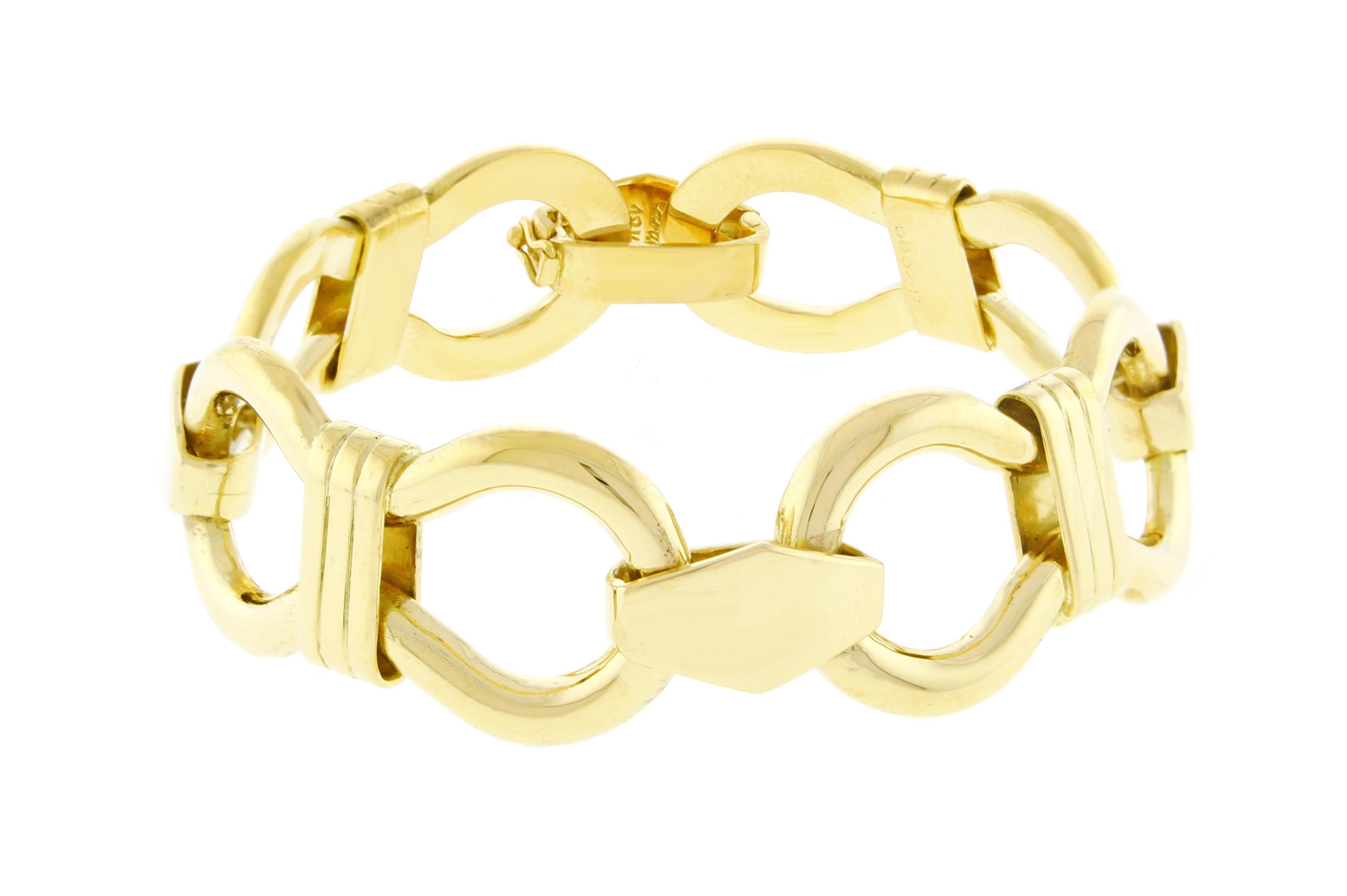 From Cartier, this elegant gold bracelet.  The 18 karat yellow gold bracelet is comprised of four interconnected banded figure eight links.  7 ¼ inches long,  21 mm wide. 75 grams